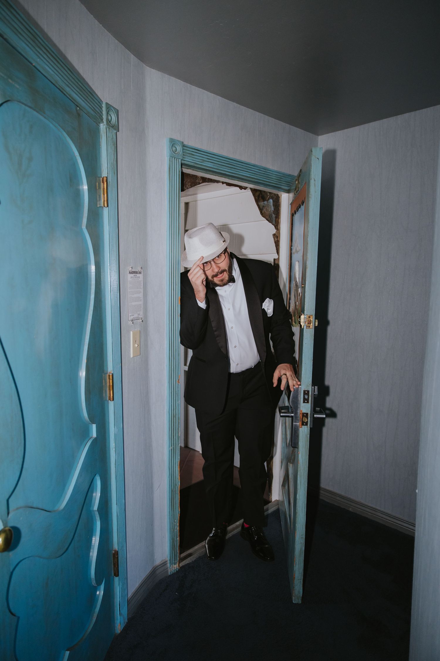 Dark hallway with turquoise walls shows multiple sequential shots of movement through the corridor.
