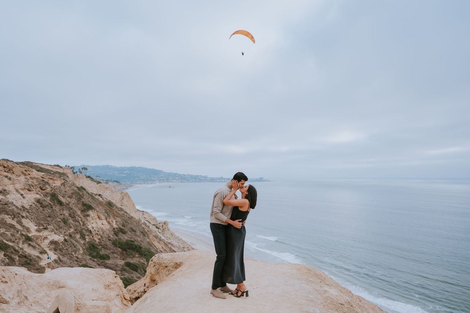 Romantic coastal engagement session along dramatic ocean cliffs.