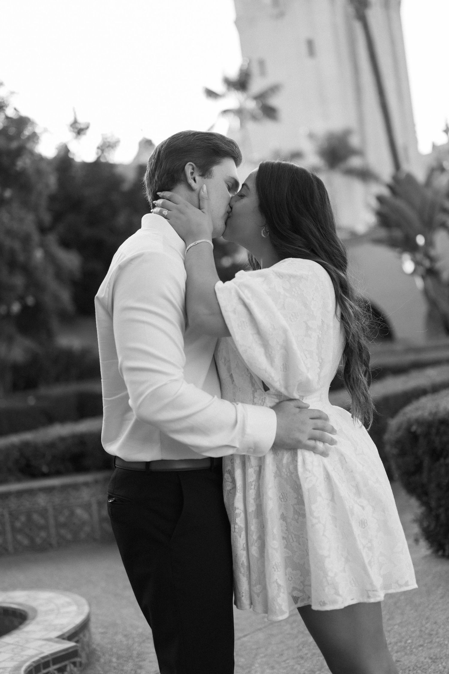 Black and white romantic portrait session in an outdoor garden setting.