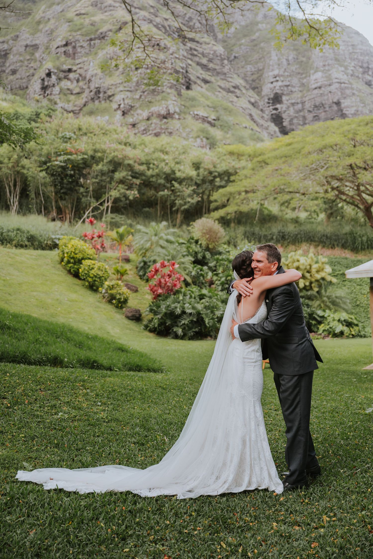 A romantic wedding photoshoot sequence in a lush garden setting with mountains in the background.