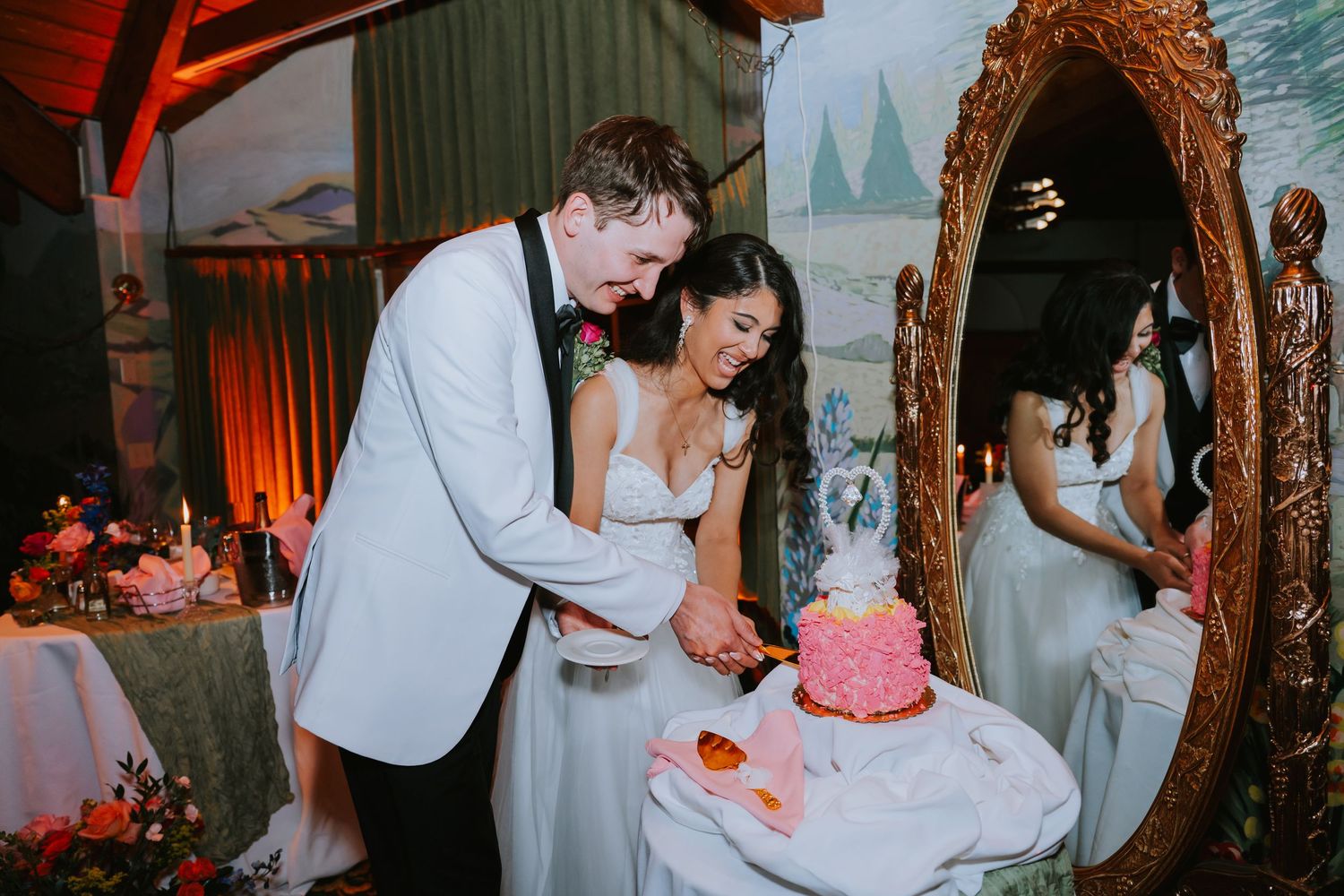 Couple shares intimate moments during their wedding reception in a rustic barn with warm lighting.