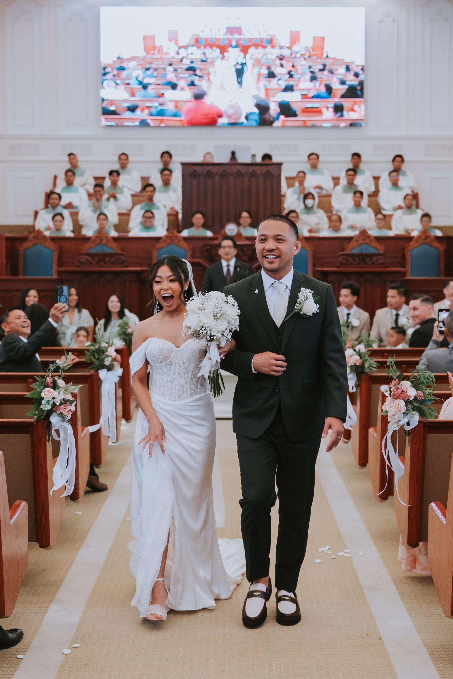 Wedding party walks down church aisle in sequence showing progression from back to front of sanctuary.