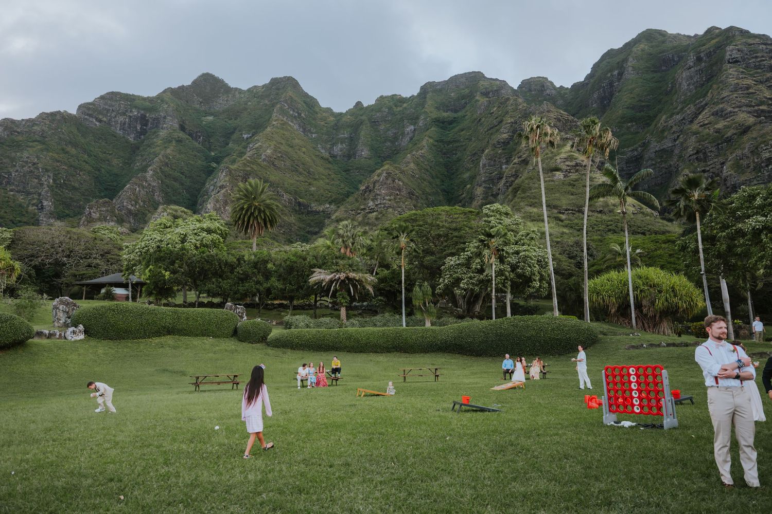 Wedding ceremony venue with mountain backdrop and tropical landscaping in Hawaii.