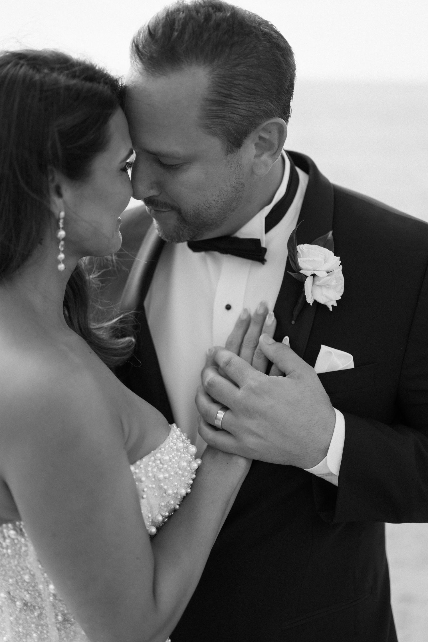 Intimate black and white wedding photography captures romantic moments between newlyweds.