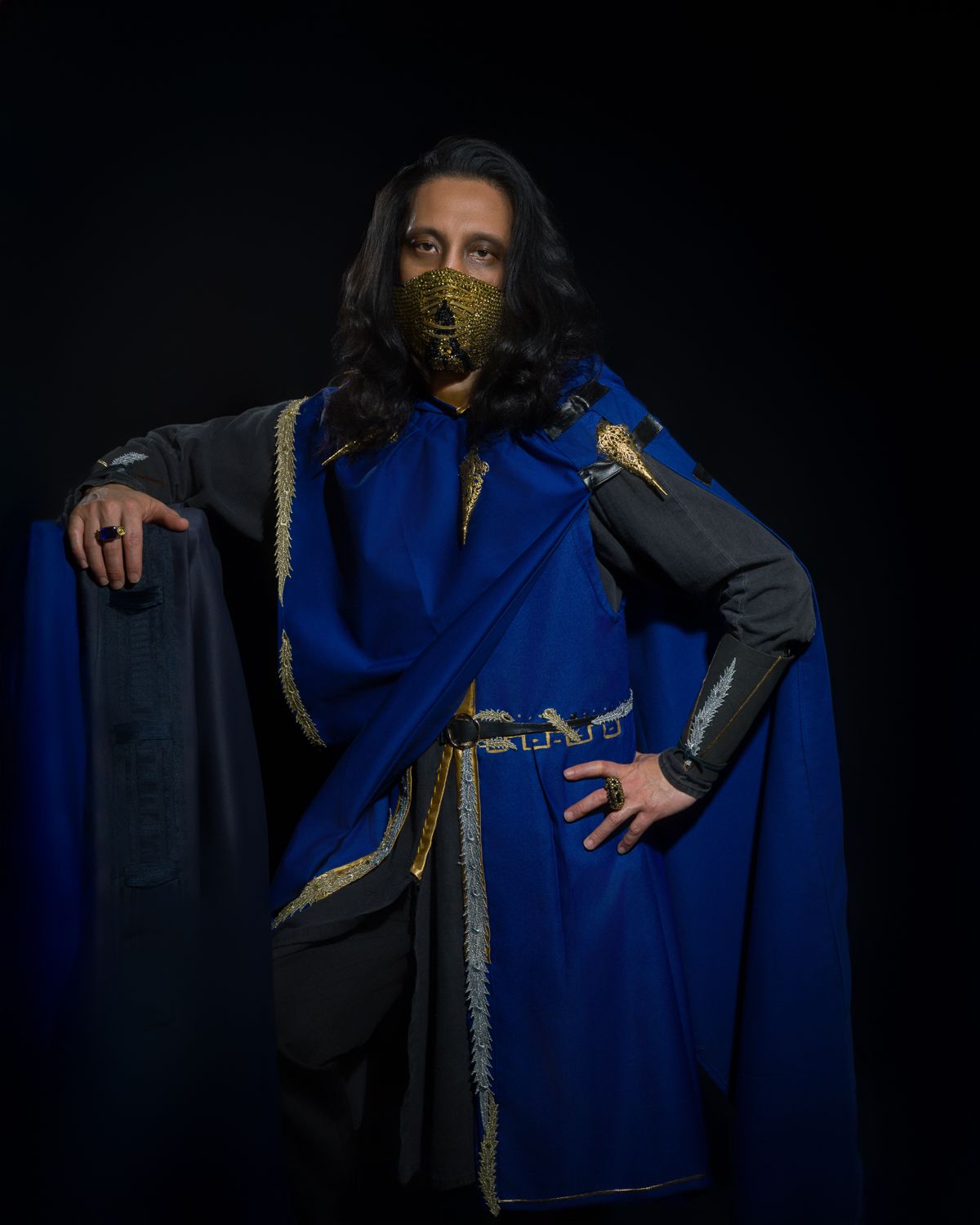 Cosplay theme style portrait of The King, wearing royal blue wardrobes with gold highlight, wearing golden face mask