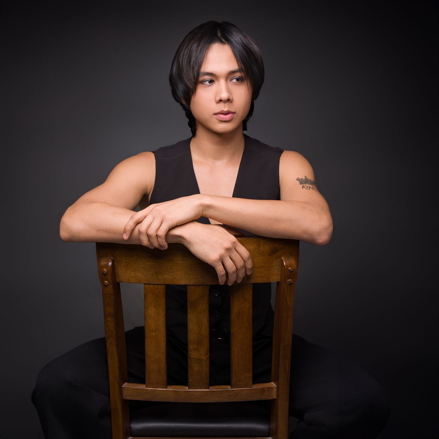 A young man's portrait and sitting in a chair