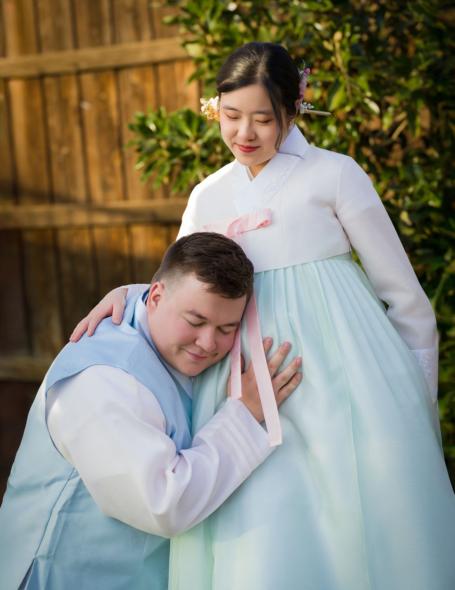 Pregnancy portraits of a couple wearing HanBok ( Korean Traditional gown), moment of connection between soon to be a dad.