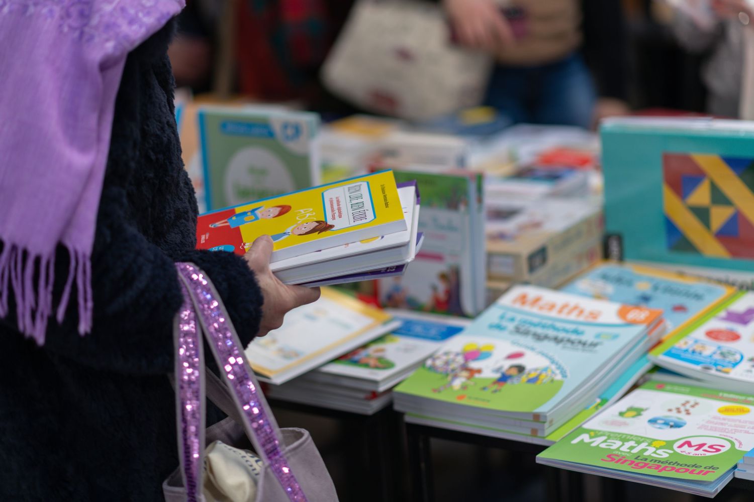 Educational books and materials displayed at school event.