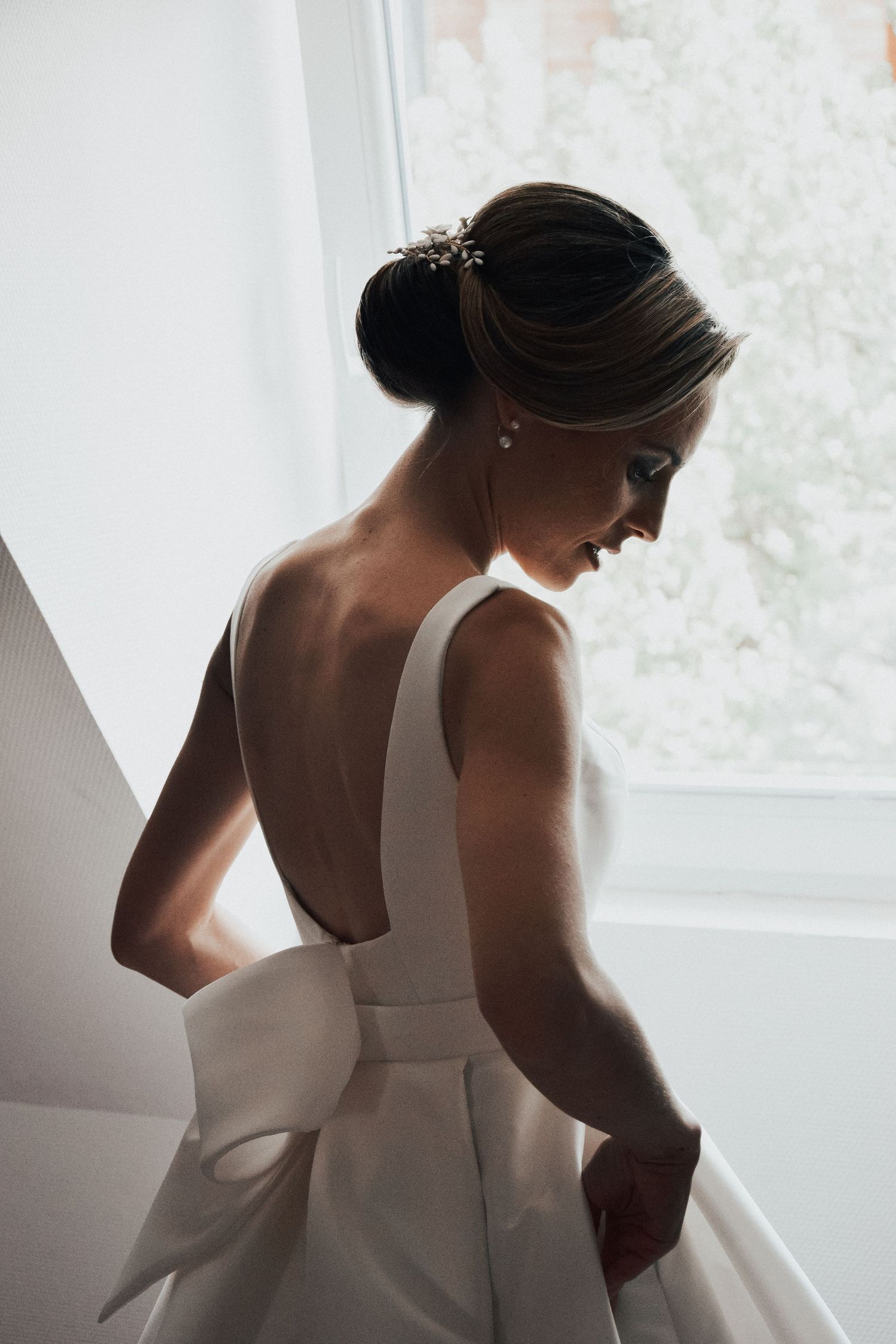 Back view of elegant white wedding dress with dramatic bow detail.