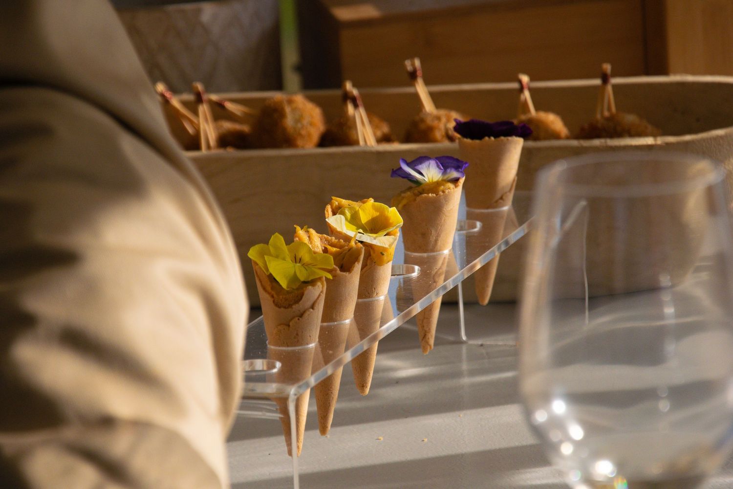 Freshly baked pastries and breads hanging from wooden pegs in a rustic bakery display.