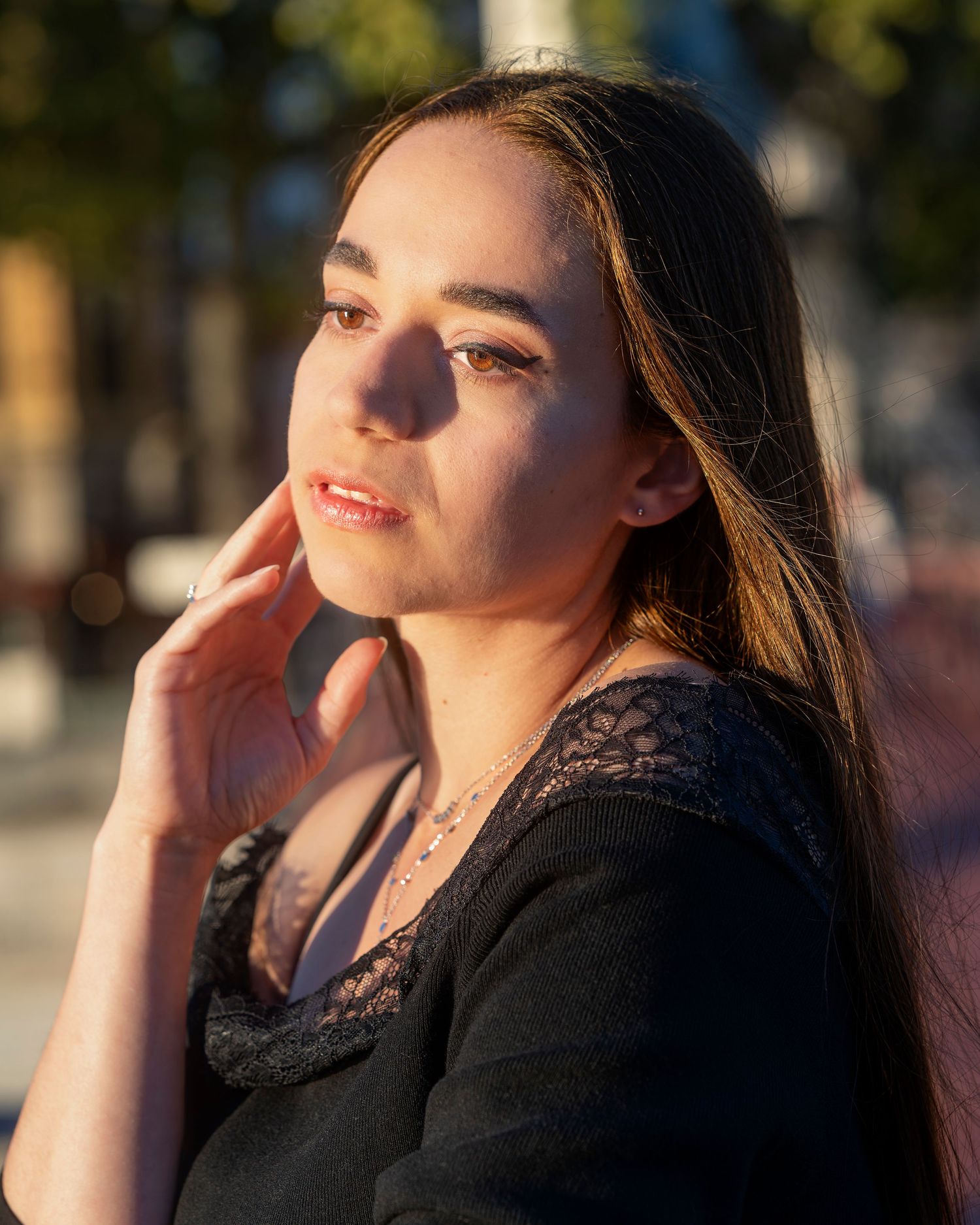 Person poses in profile view against sunlit backdrop in series of connected photographs.