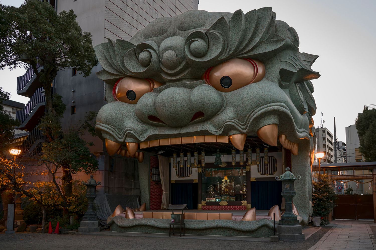 Giant demon face building entrance at Namba Yasaka Shrine in Osaka, Japan, a unique architectural landmark.