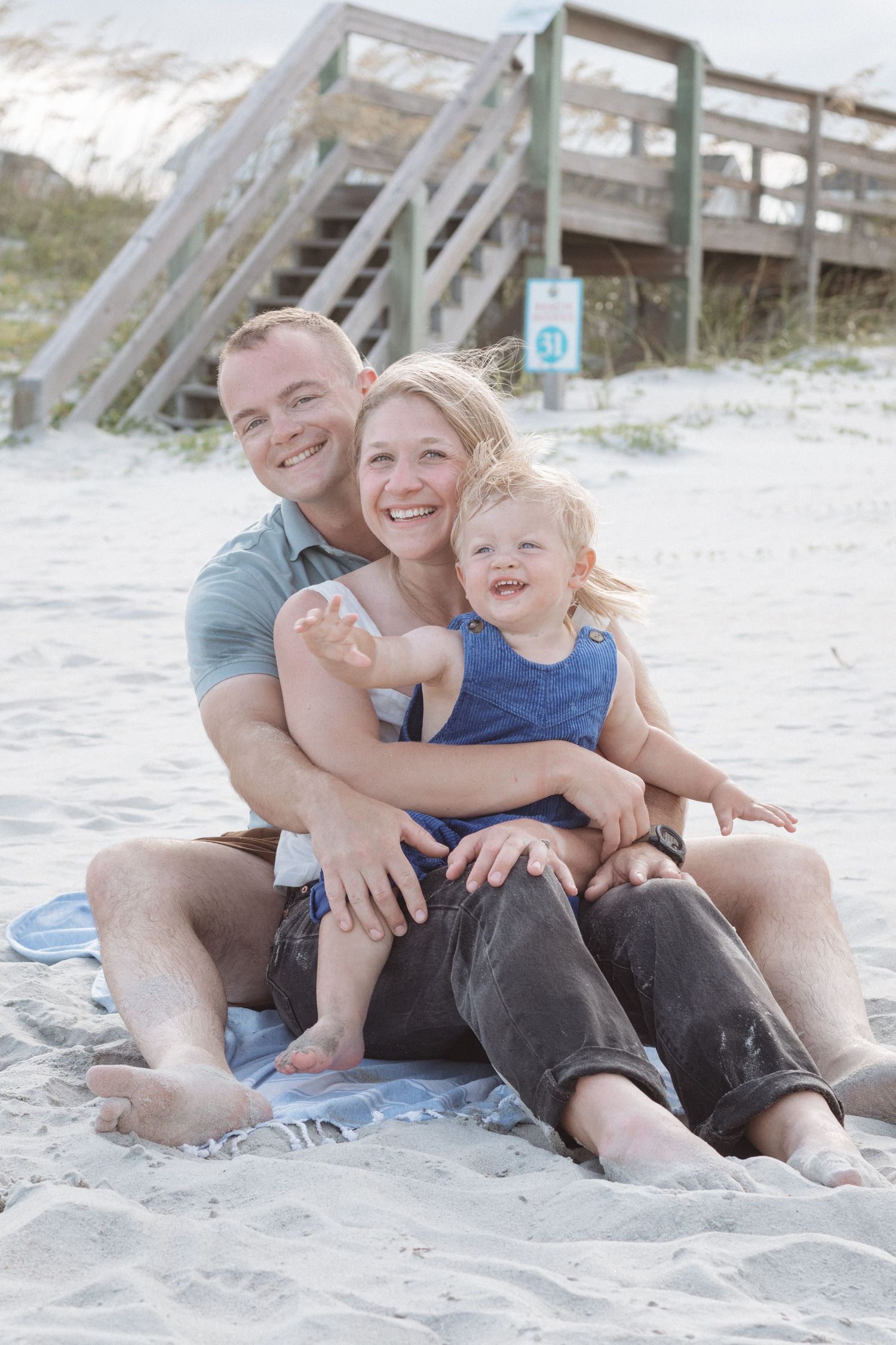 A joyful family moment captured in a series of candid photos on a sandy beach.