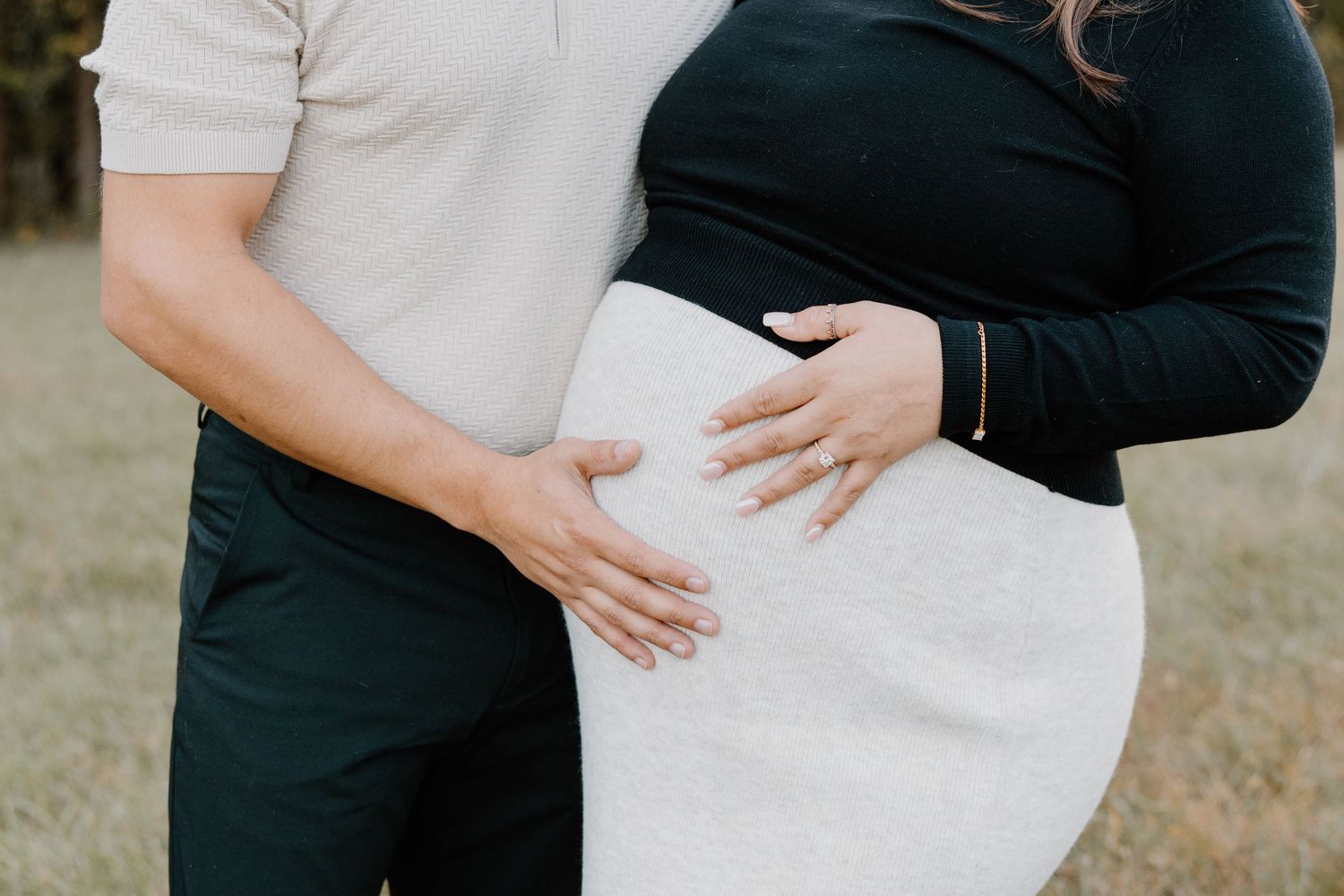 A series of maternity photos showing a couple embracing outdoors in white and black attire.