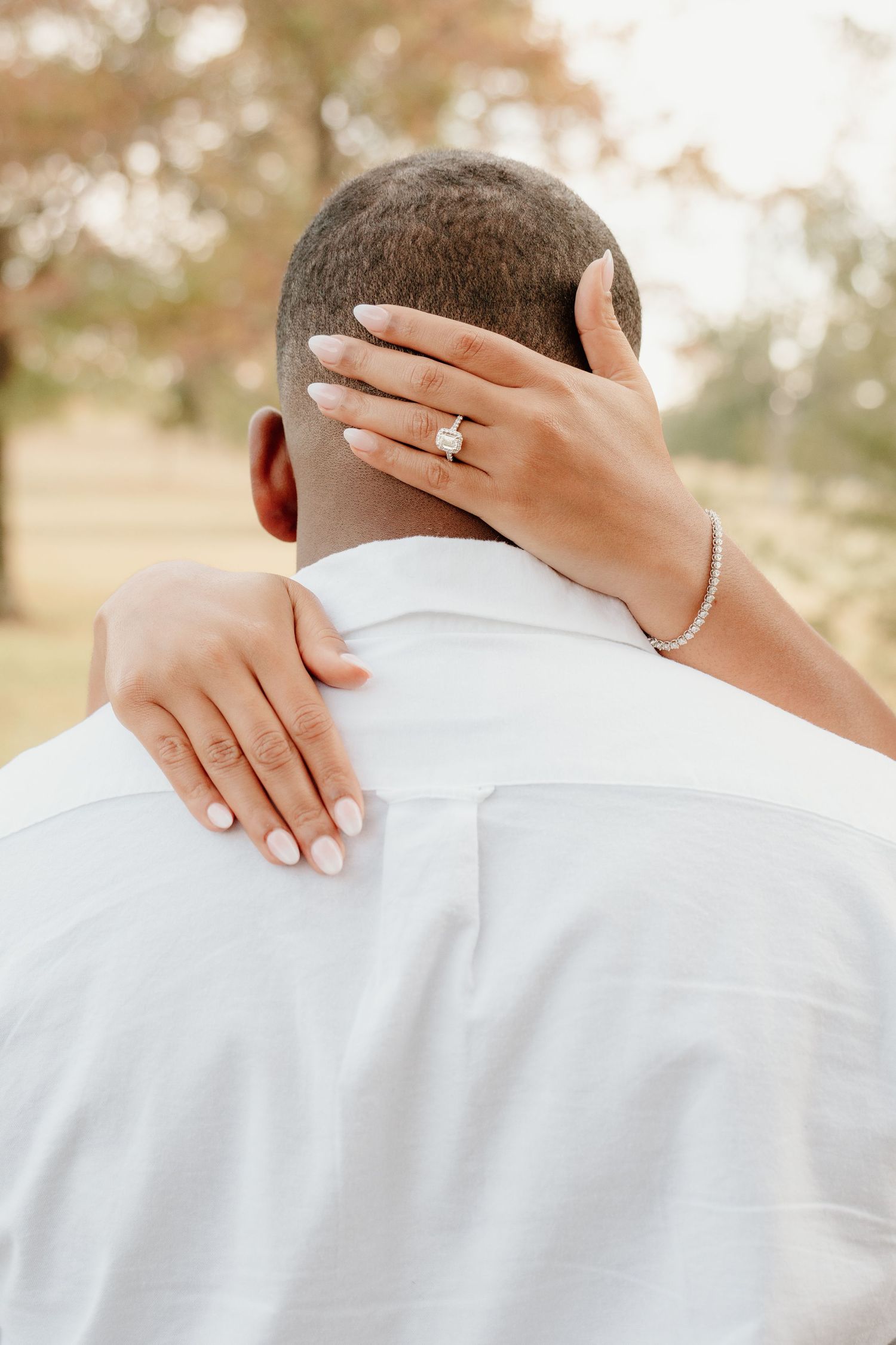Close-up photo series showing an engagement ring on a hand resting against a white dress shirt in warm sunlight.