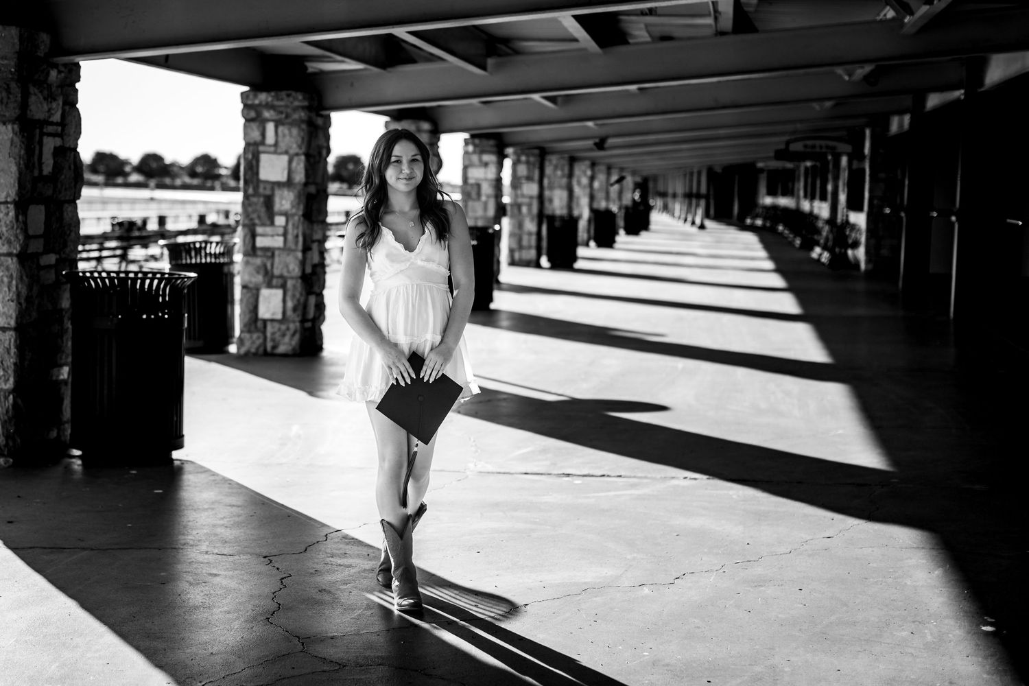 Long shadows cast by commuters on a train platform during golden hour create dramatic lighting patterns.
