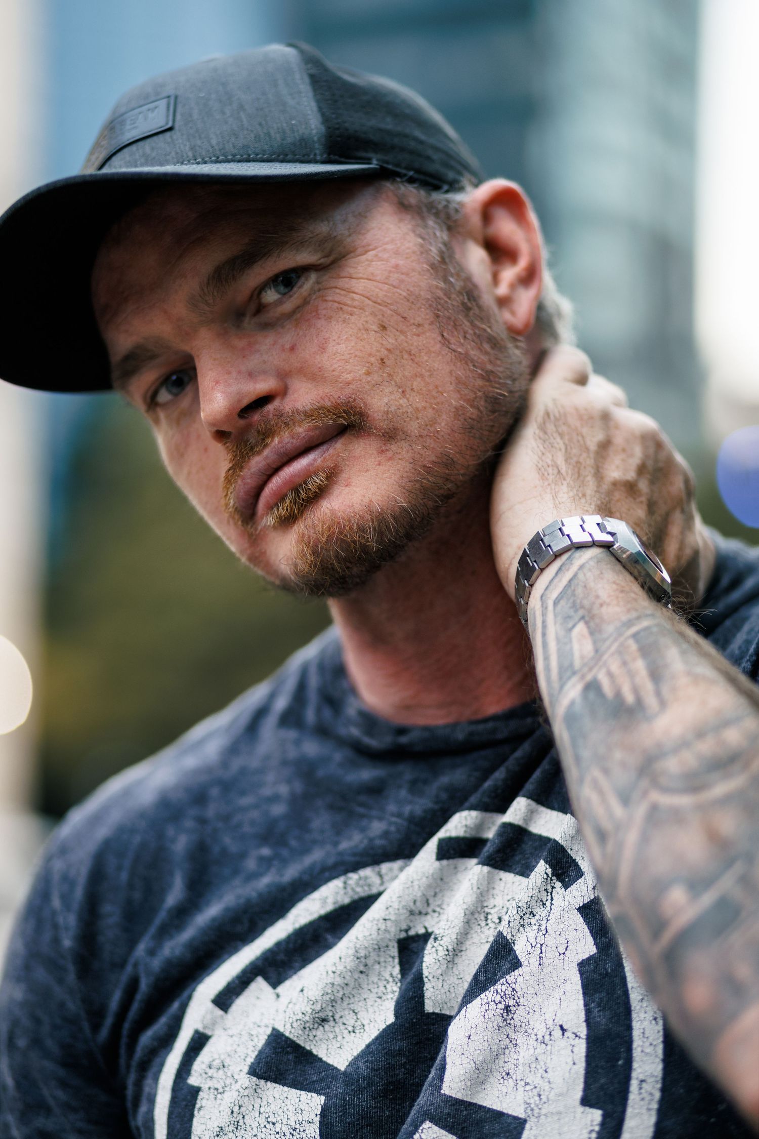 A person wearing a baseball cap and dark shirt with white text is photographed in multiple close-up angles.