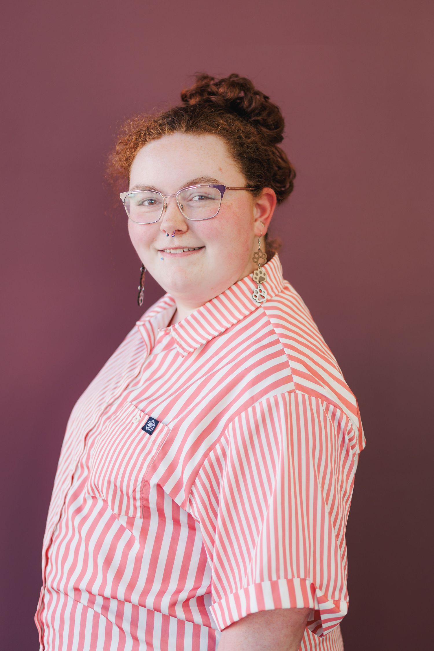 Person wearing red and white striped button-up shirt poses against mauve background in sequential photos.