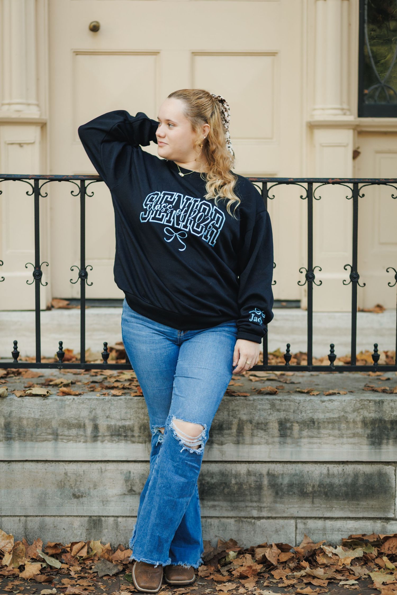 Four sequential photos show someone in a black sweatshirt and ripped jeans posing against a concrete wall with autumn leaves.