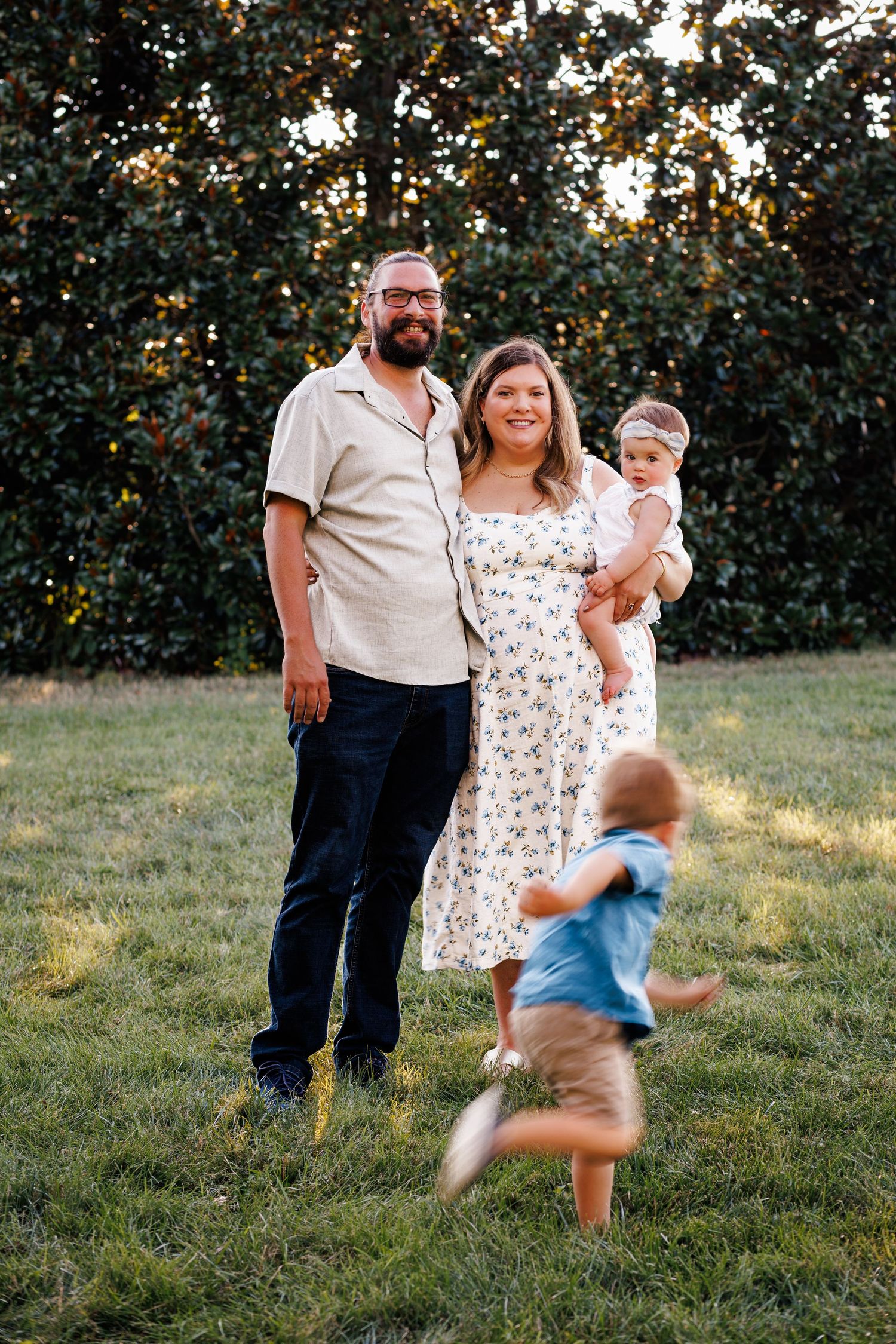 A family photoshoot sequence in a grassy outdoor setting at dusk showing a young child running and playing.