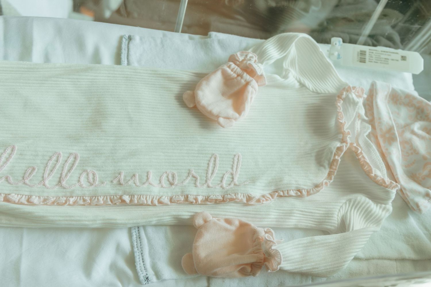 A collage of antique lace and vintage textile trim samples displays delicate white embroidered patterns.