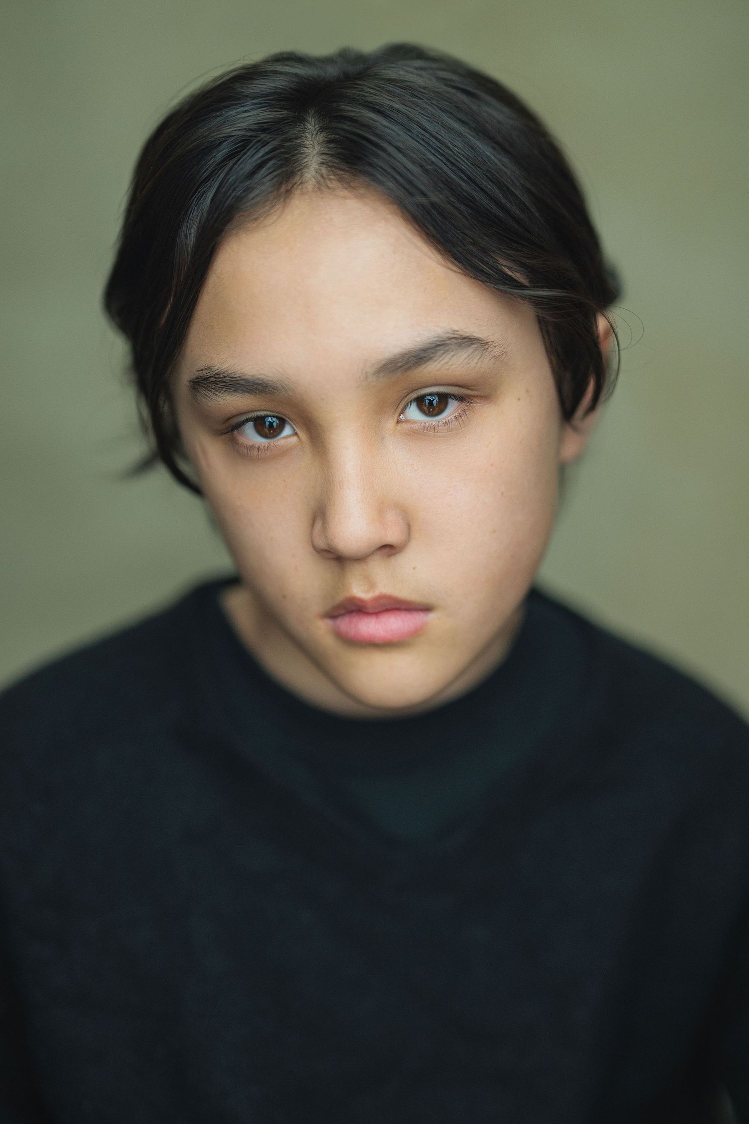 Close up portrait series showing dramatic shadows and moody lighting against a green-tinted background.