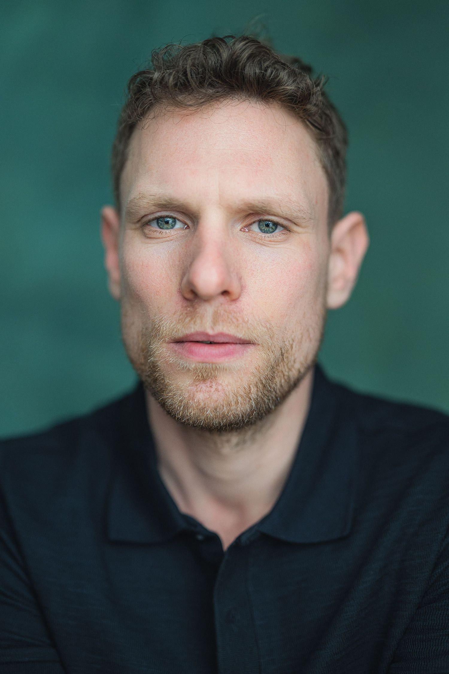 Professional headshot series against teal background showing different angles and expressions in dark attire.
