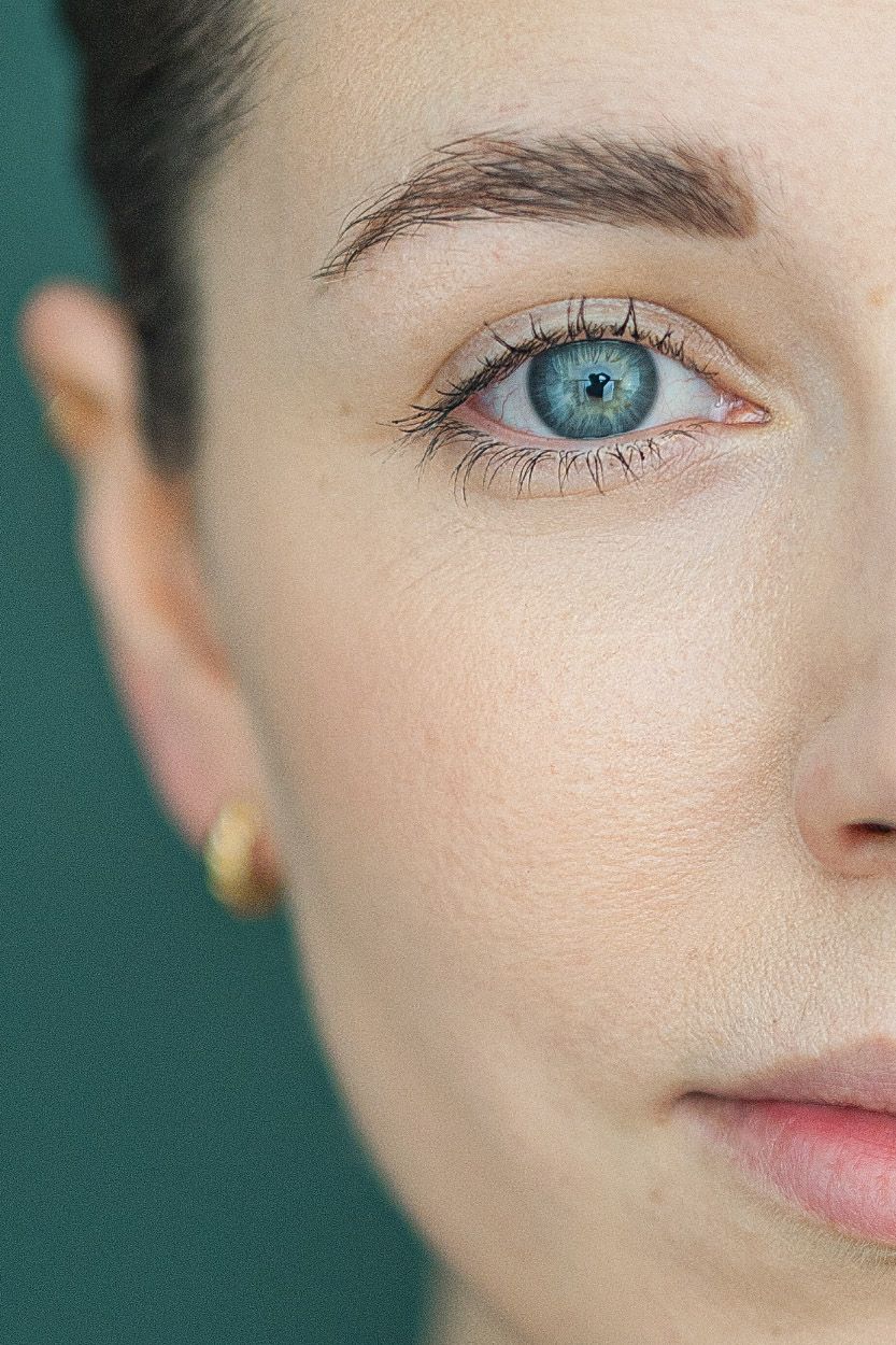 Close-up portrait series showing striking blue eyes and fair skin against a teal background.