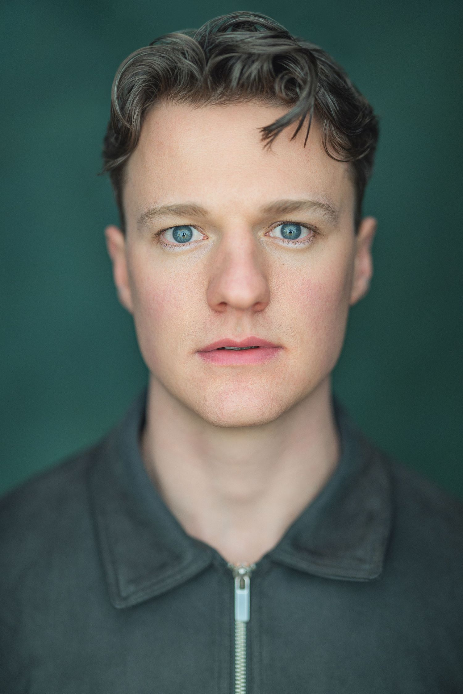 A series of four headshot portraits against a dark teal background showing different facial expressions and angles.