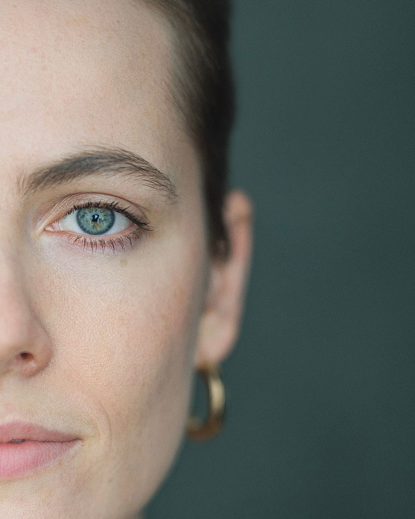Close-up portrait series showing partial facial features and striking blue eyes against a dark background.