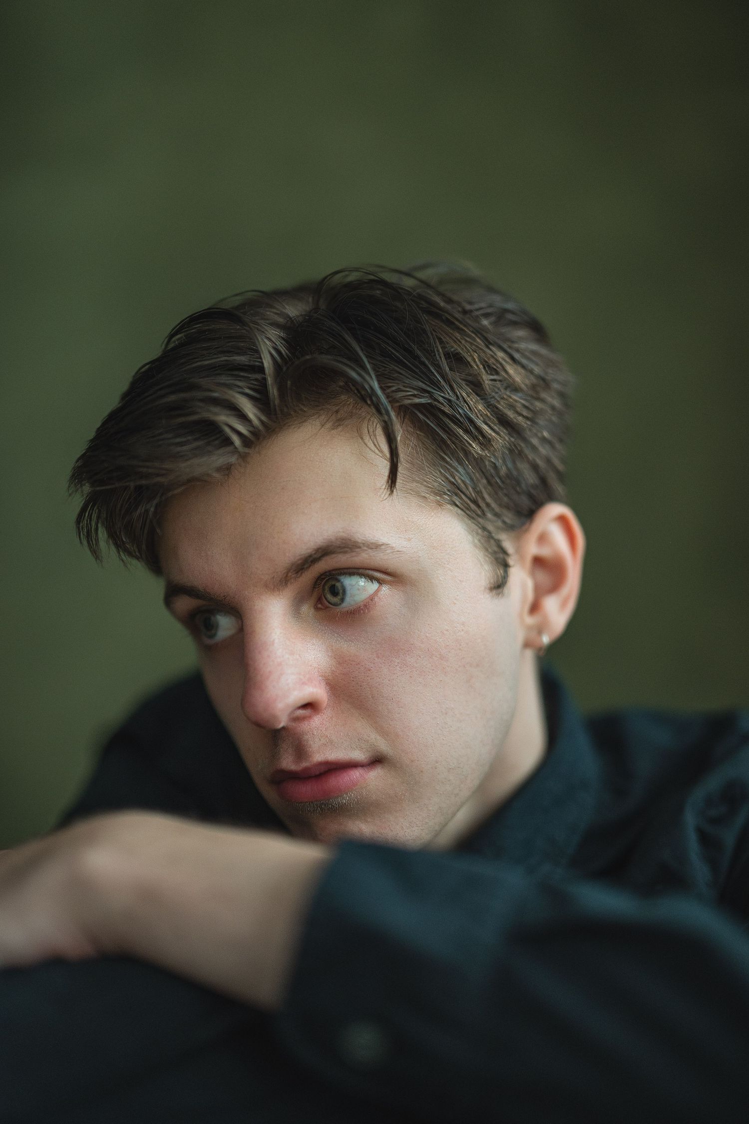 Close-up portrait series showing a person's face in a dark room with dramatic lighting and moody atmosphere.