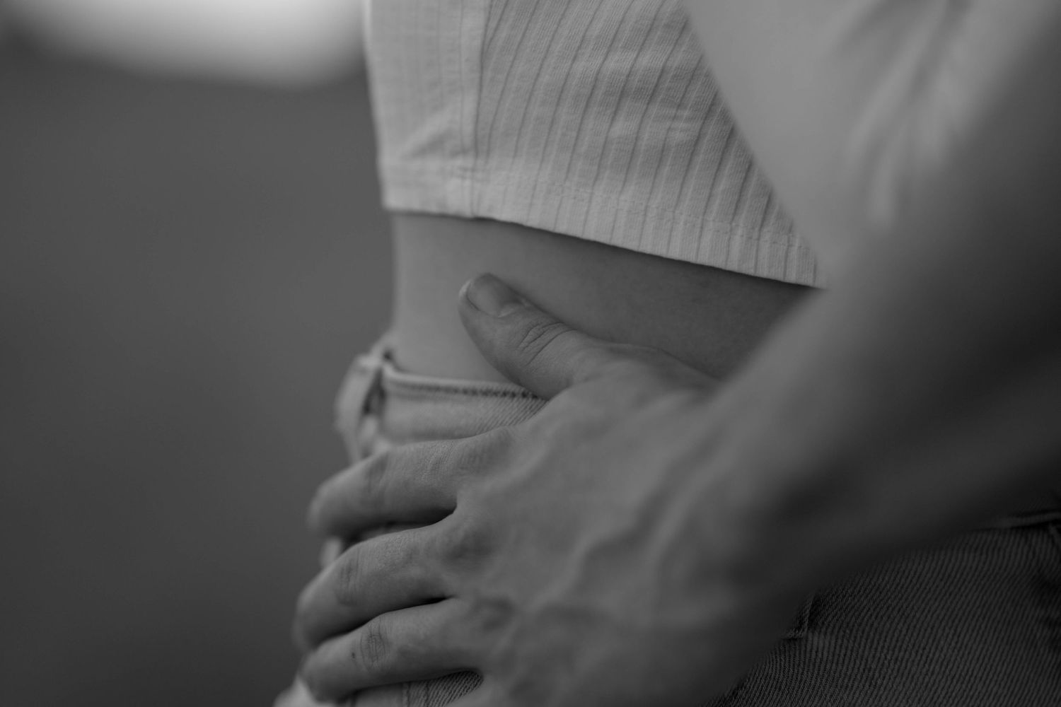 Intimate black and white photo showing gentle embrace and connection.