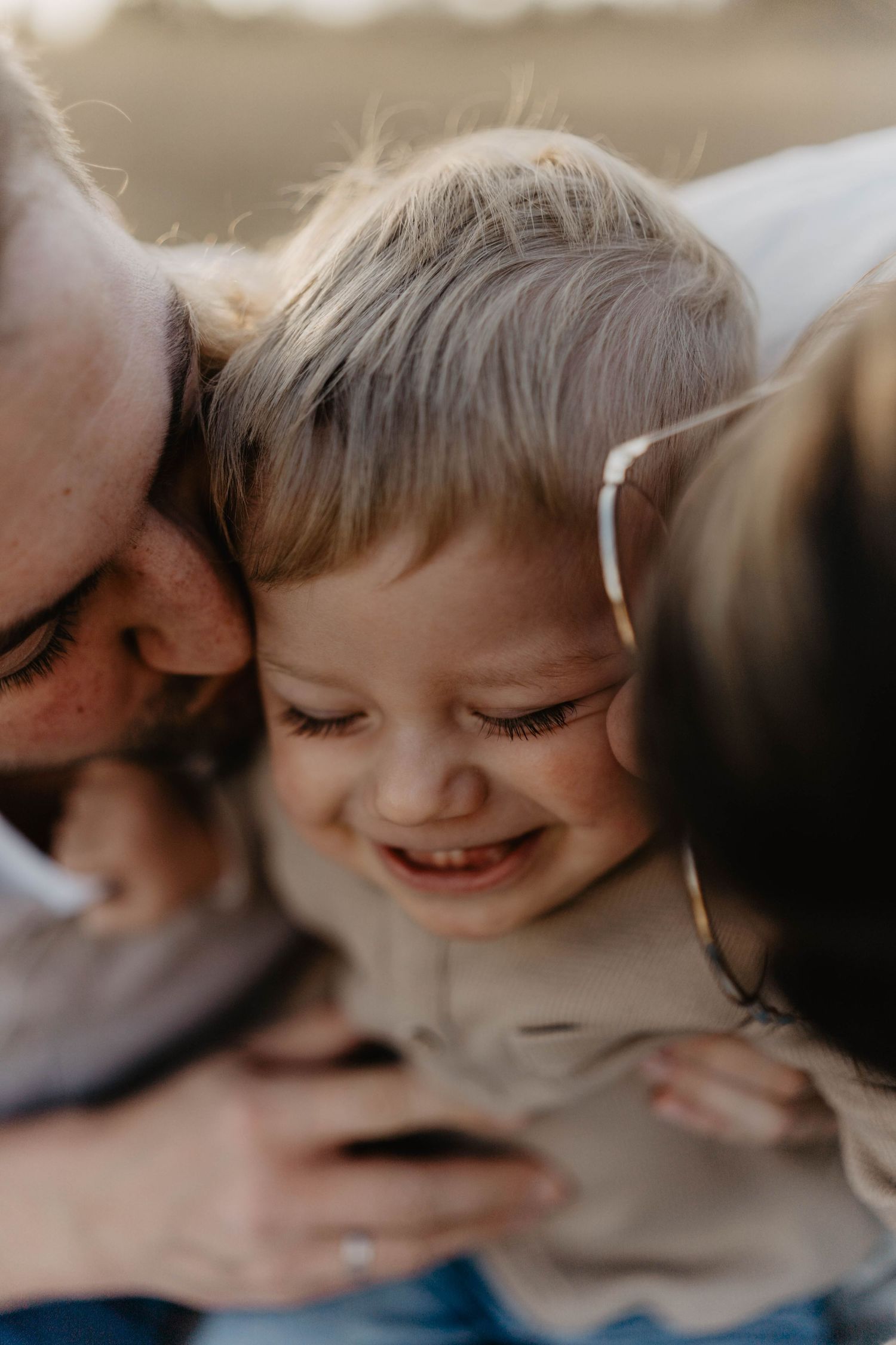 A tender family moment captured in warm sepia tones showing pure joy and closeness.