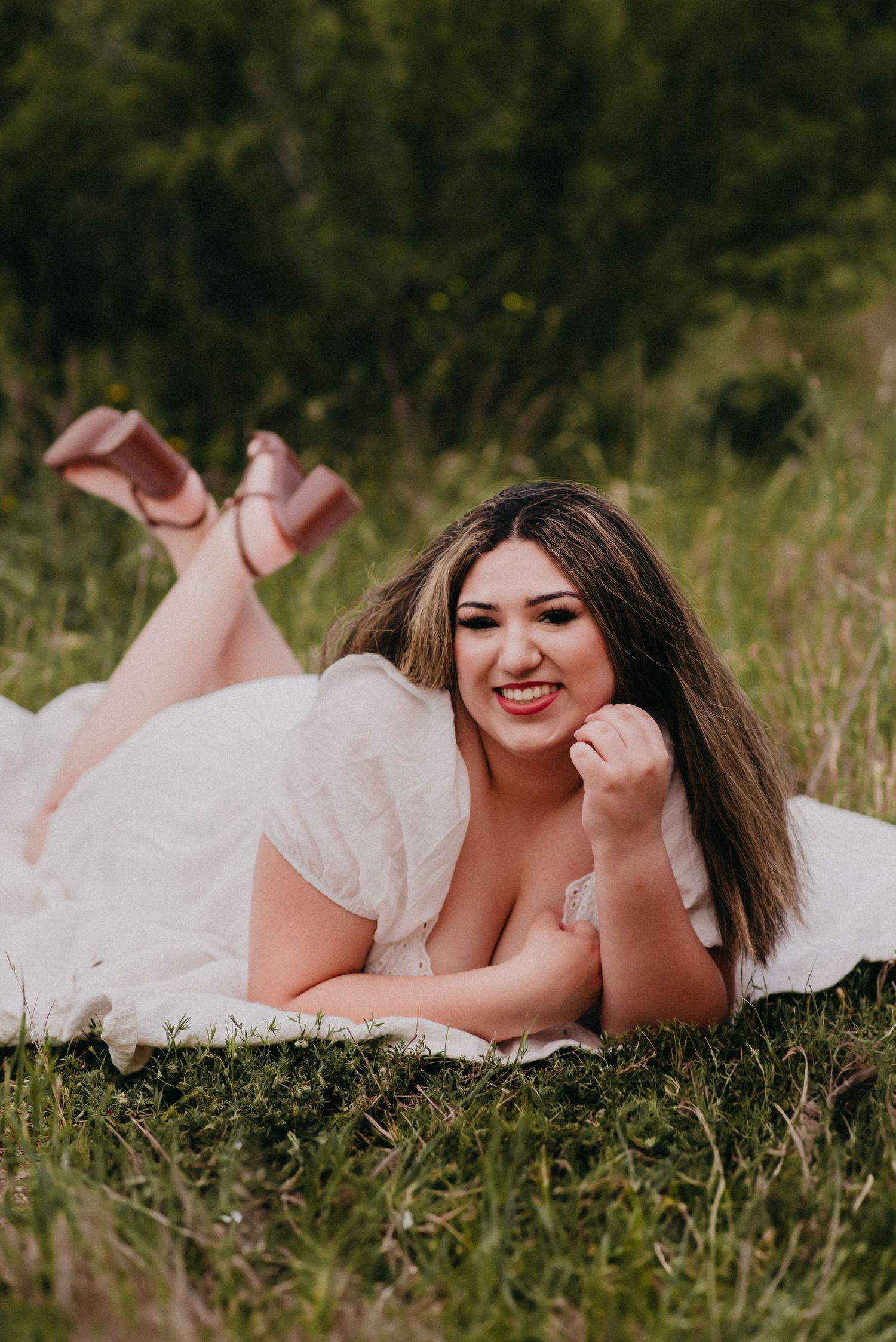 Senior girl laying in field in San Marcos, TX
