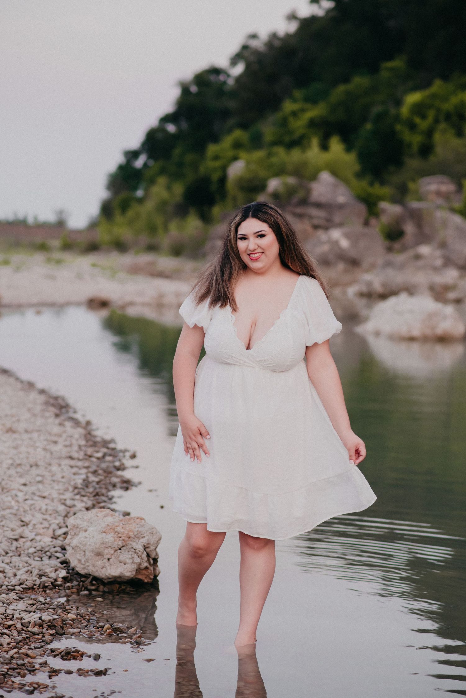 Senior girl walking in a river in San Marcos, TX