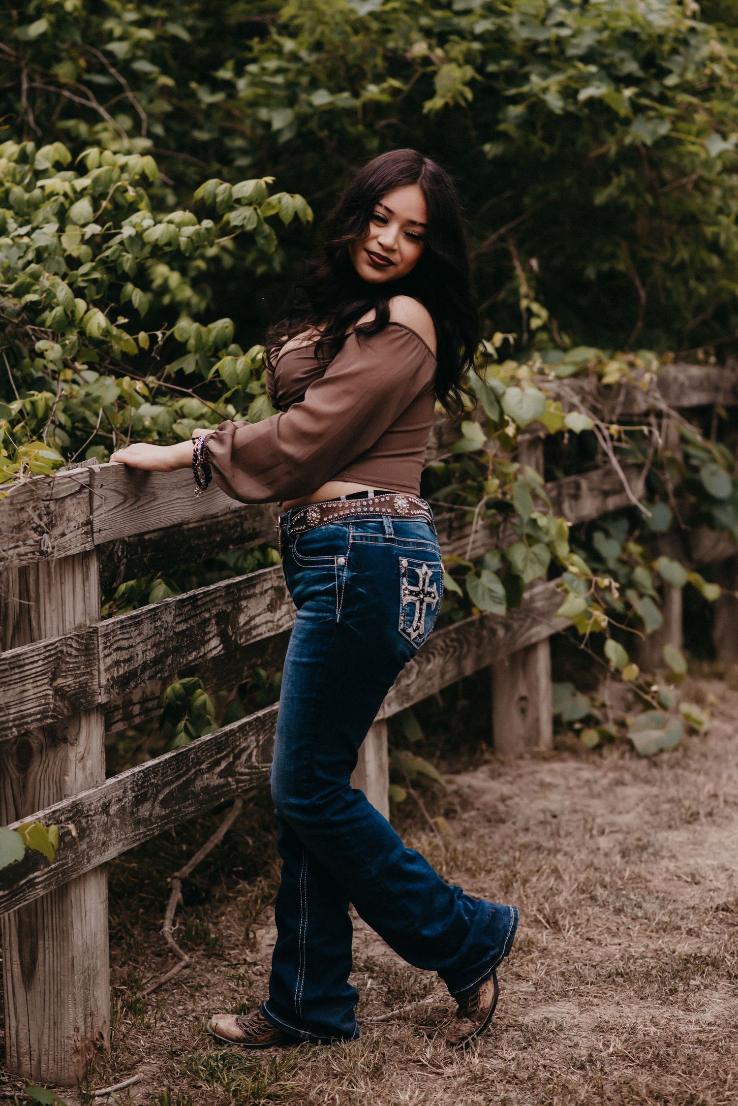 Senior girl holding onto a fence