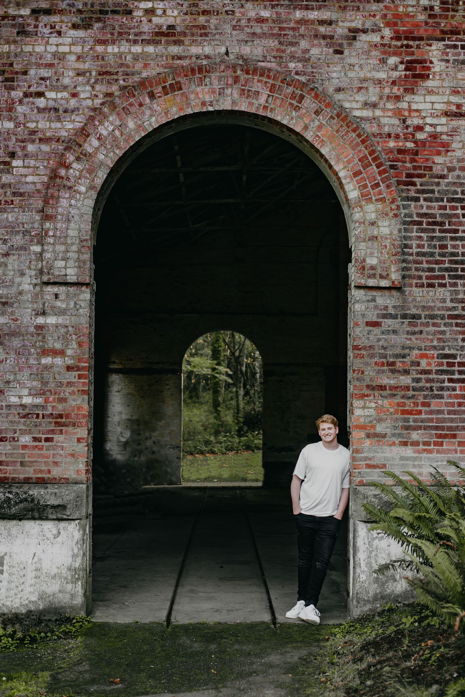 Senior boy standing in an arch