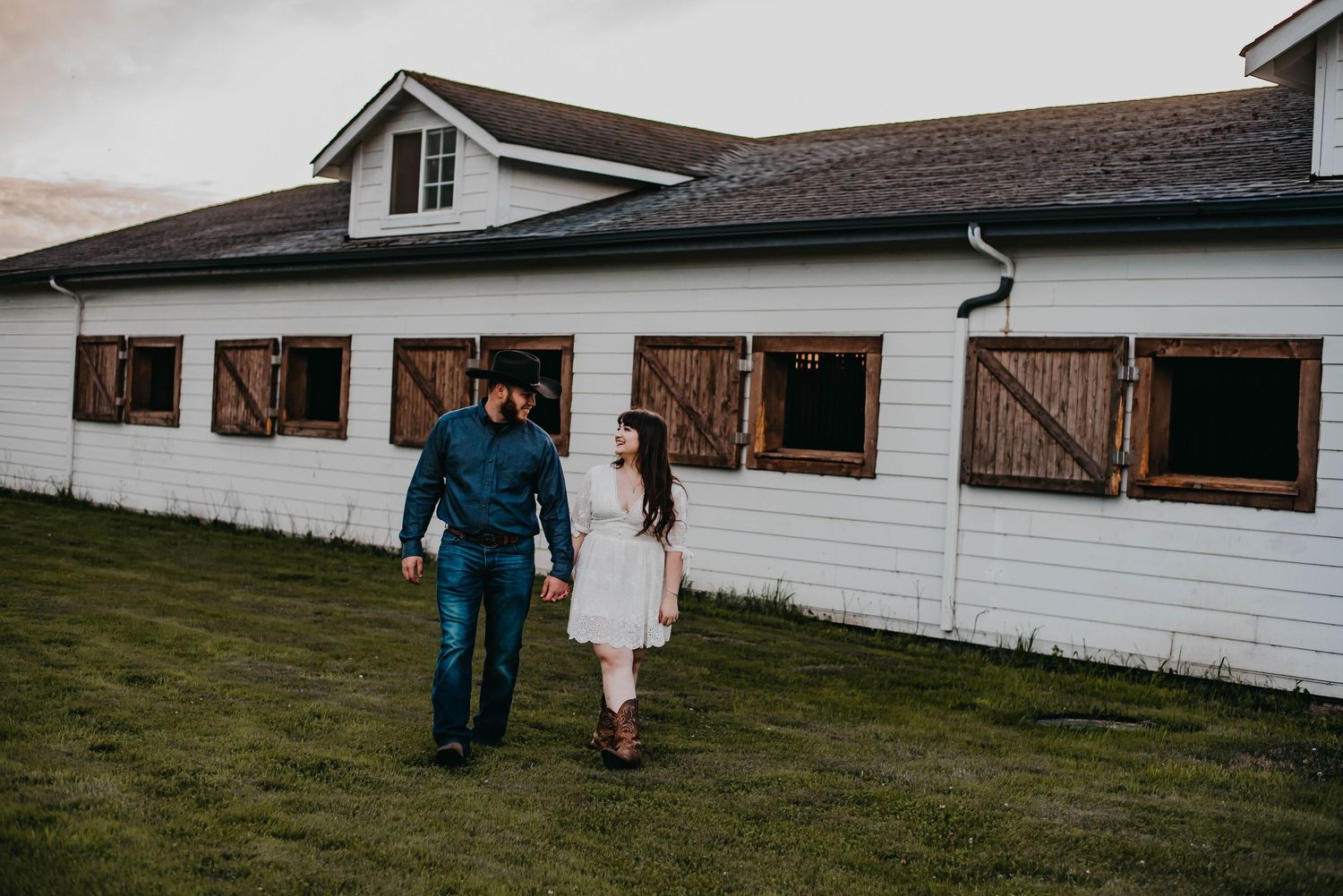 Couple walking away from a barn