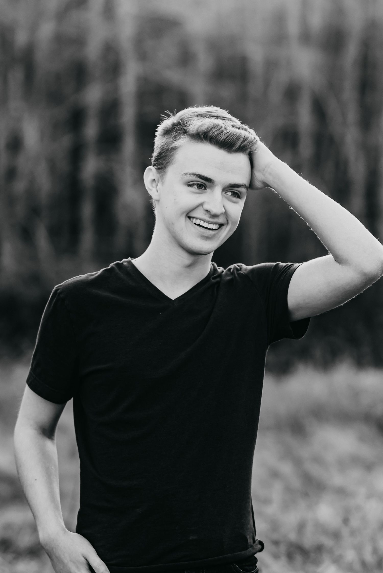 Senior boy standing in a field
