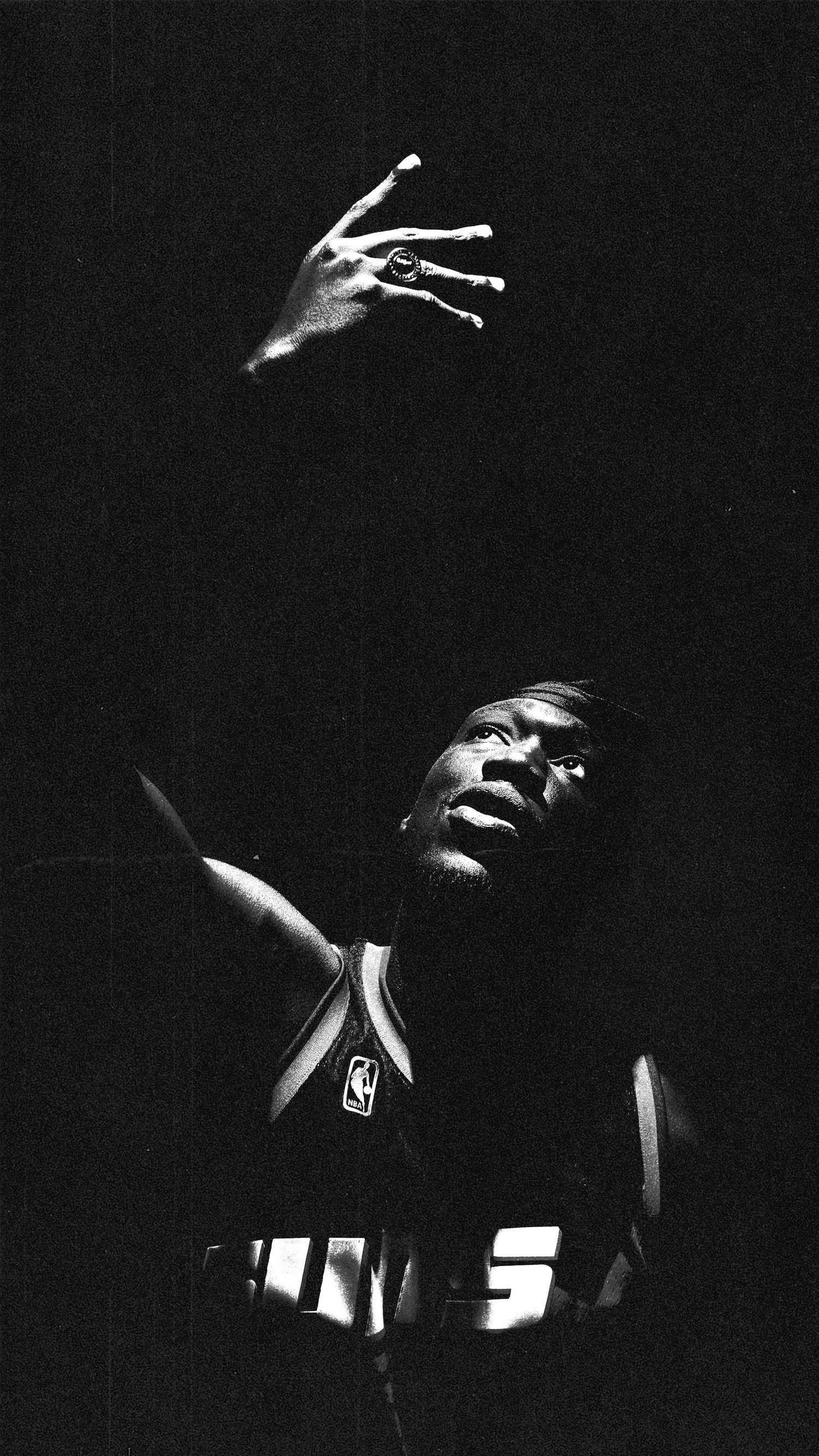 Athletic figure in NBA uniform photographed with dramatic contrast and shadows.