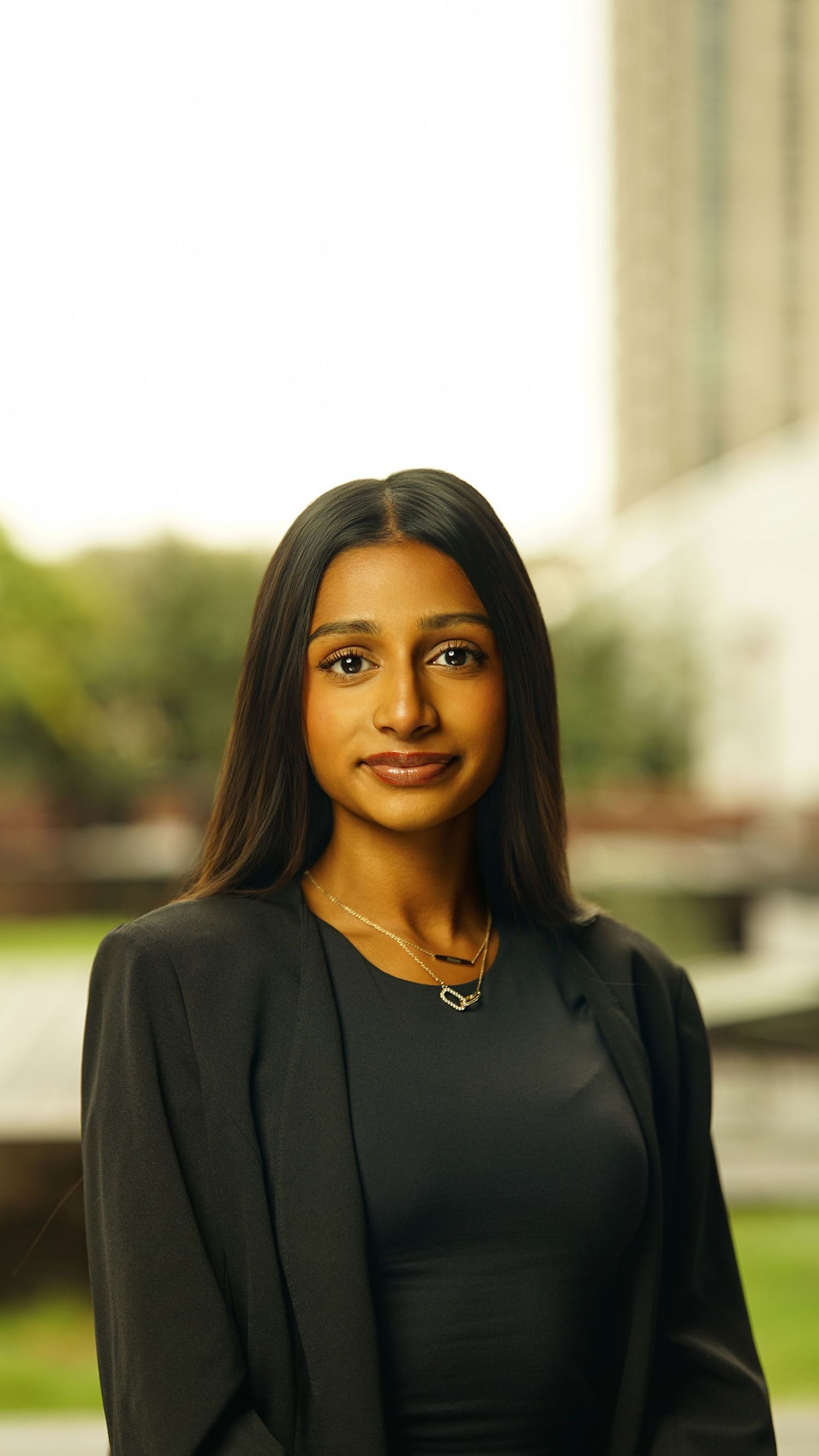 Professional portrait series showing a person in a black blazer against a light outdoor background.