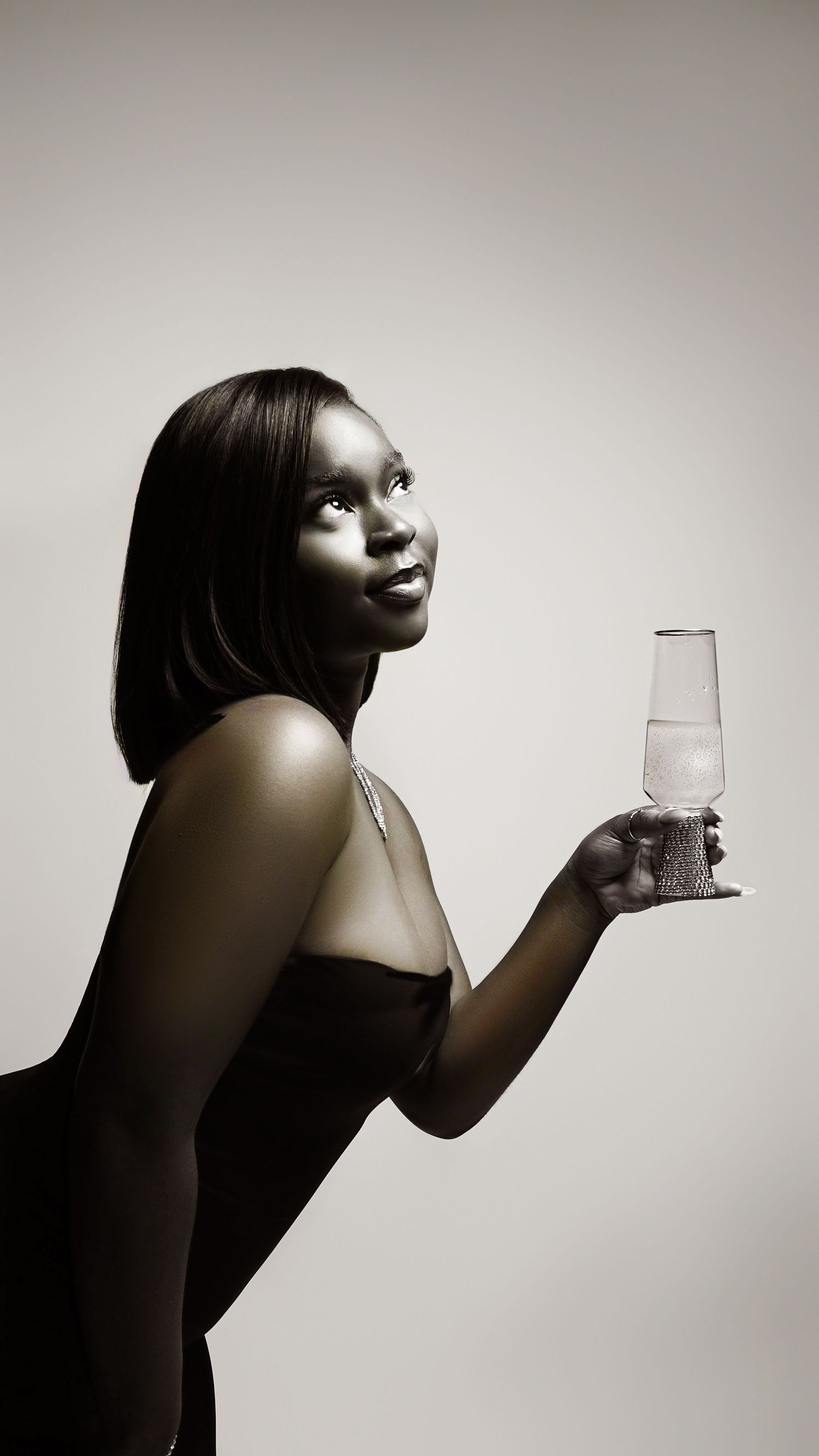 Dramatic black and white portrait series featuring figure holding wine glass with artistic lighting.