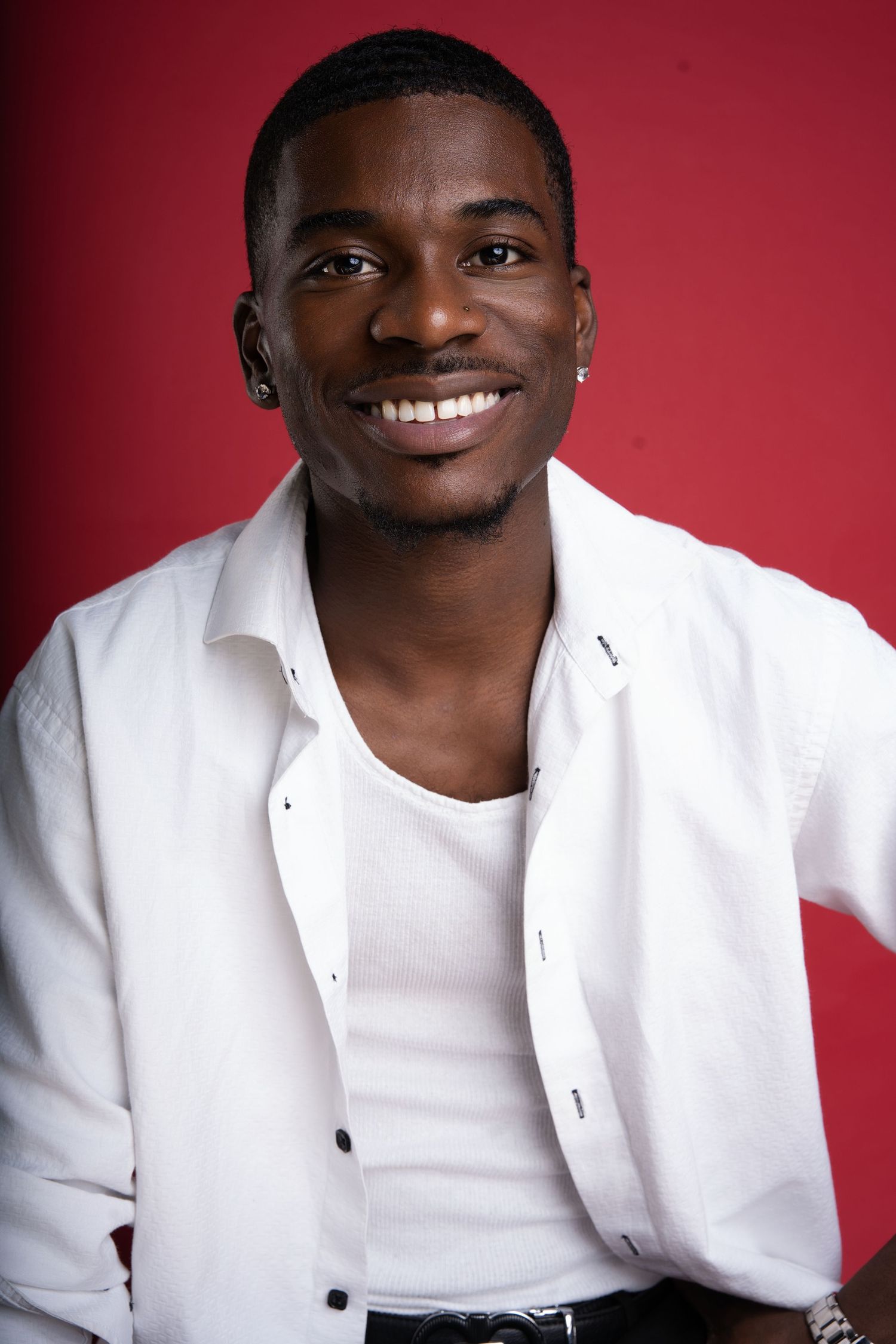 Professional headshot series showing bright smile and white blazer against red background.