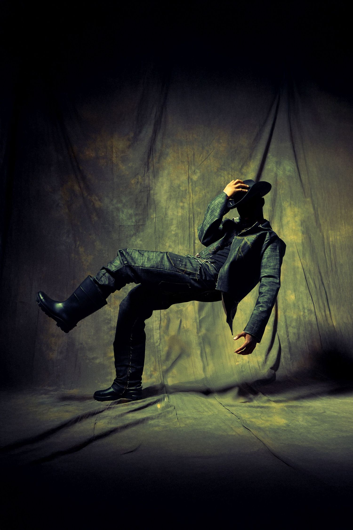 Artistic photo sequence showing a person falling and rolling in dramatic shadows against a textured wall.