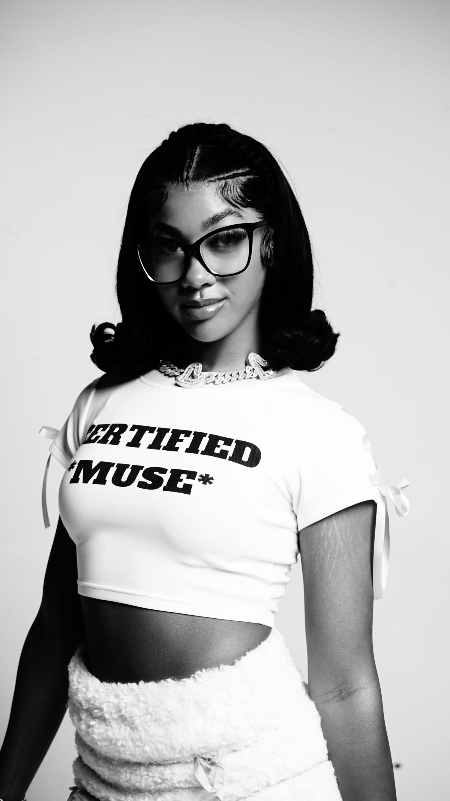 Black and white fashion photos featuring a white crop top with text and stylish glasses.