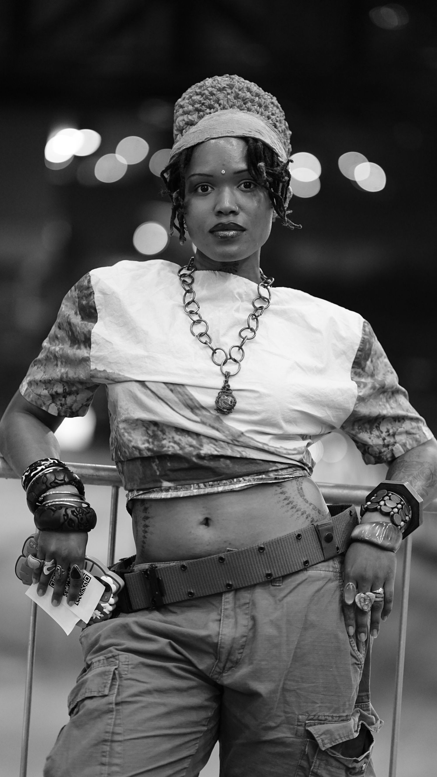 Black and white portrait showing statement necklace and vintage-inspired styling.