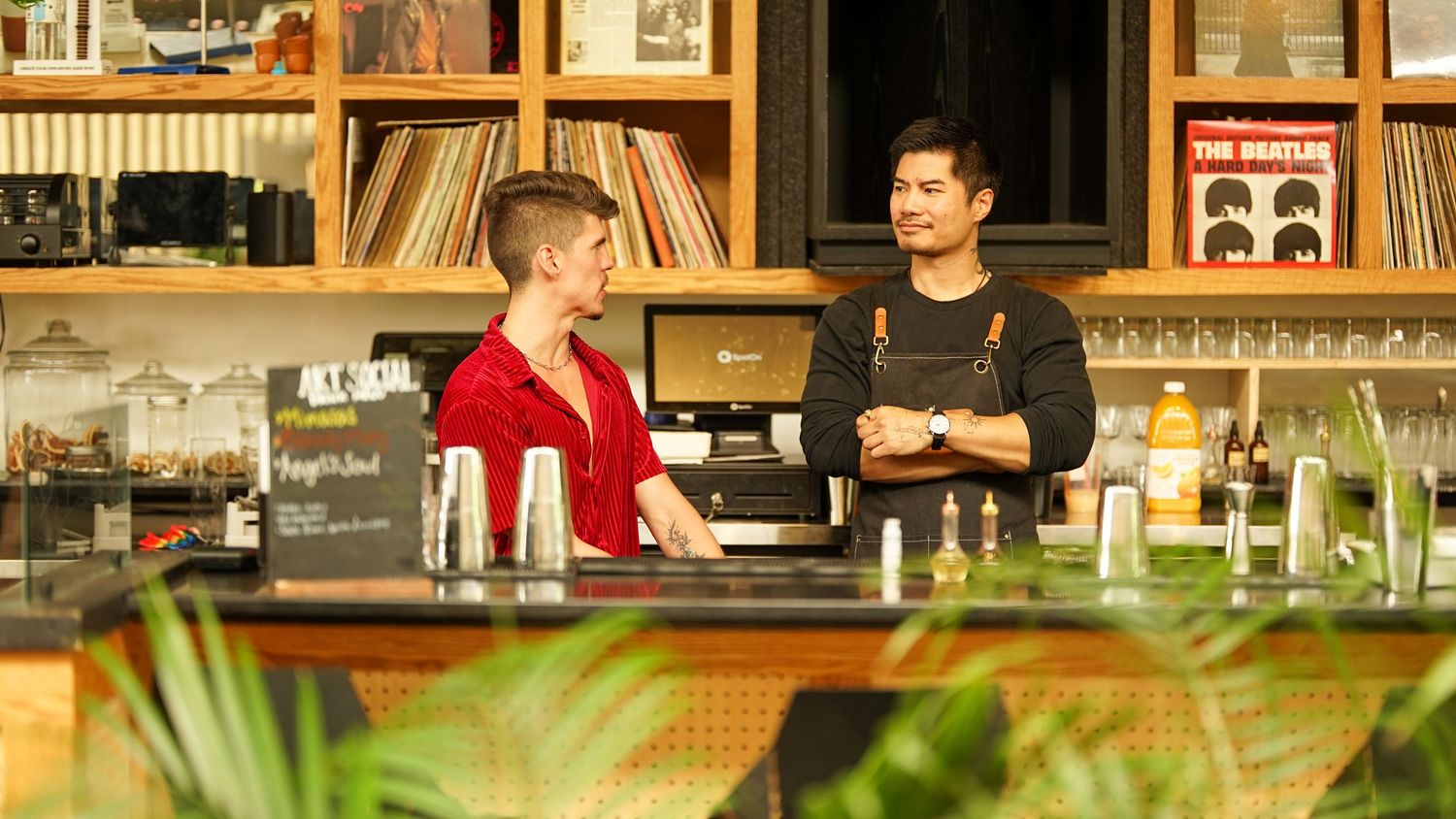 People gathered at a bar or counter area during an outdoor event.