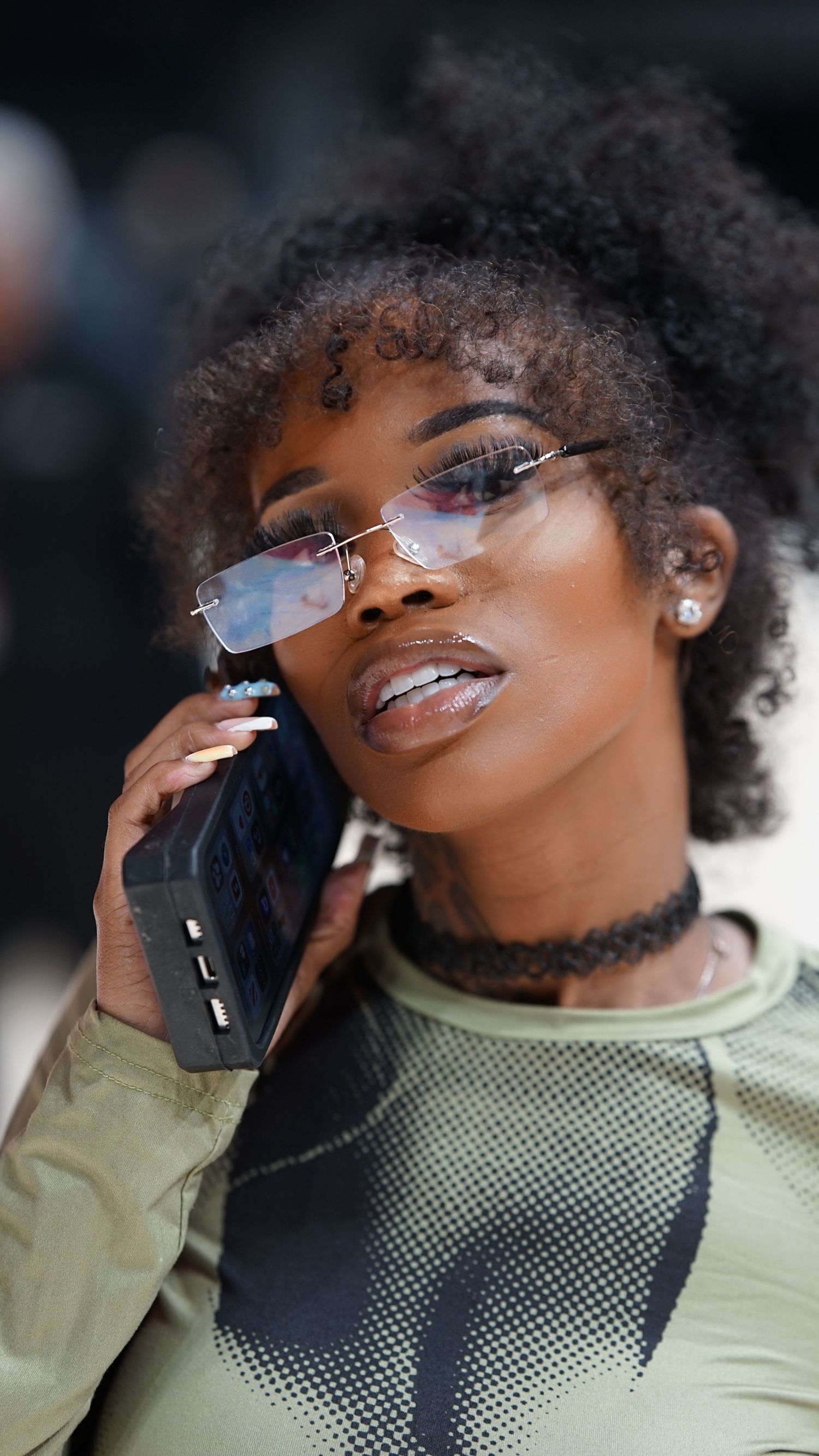 A series of artistic portraits featuring reflective glasses and a light green mesh top against a dark background.