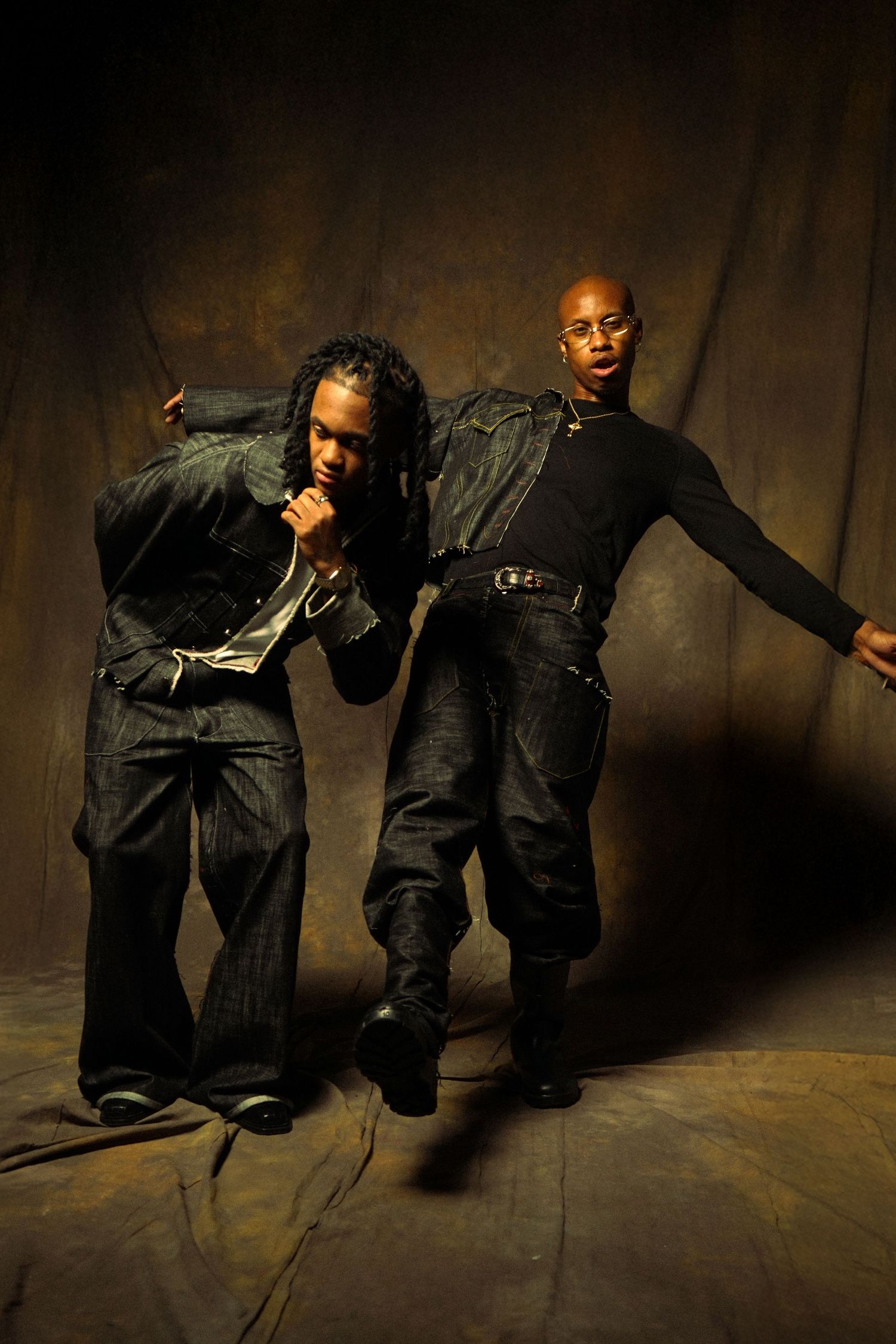 A sequence of dramatic dance moves performed on the floor in moody lighting against a dark background.
