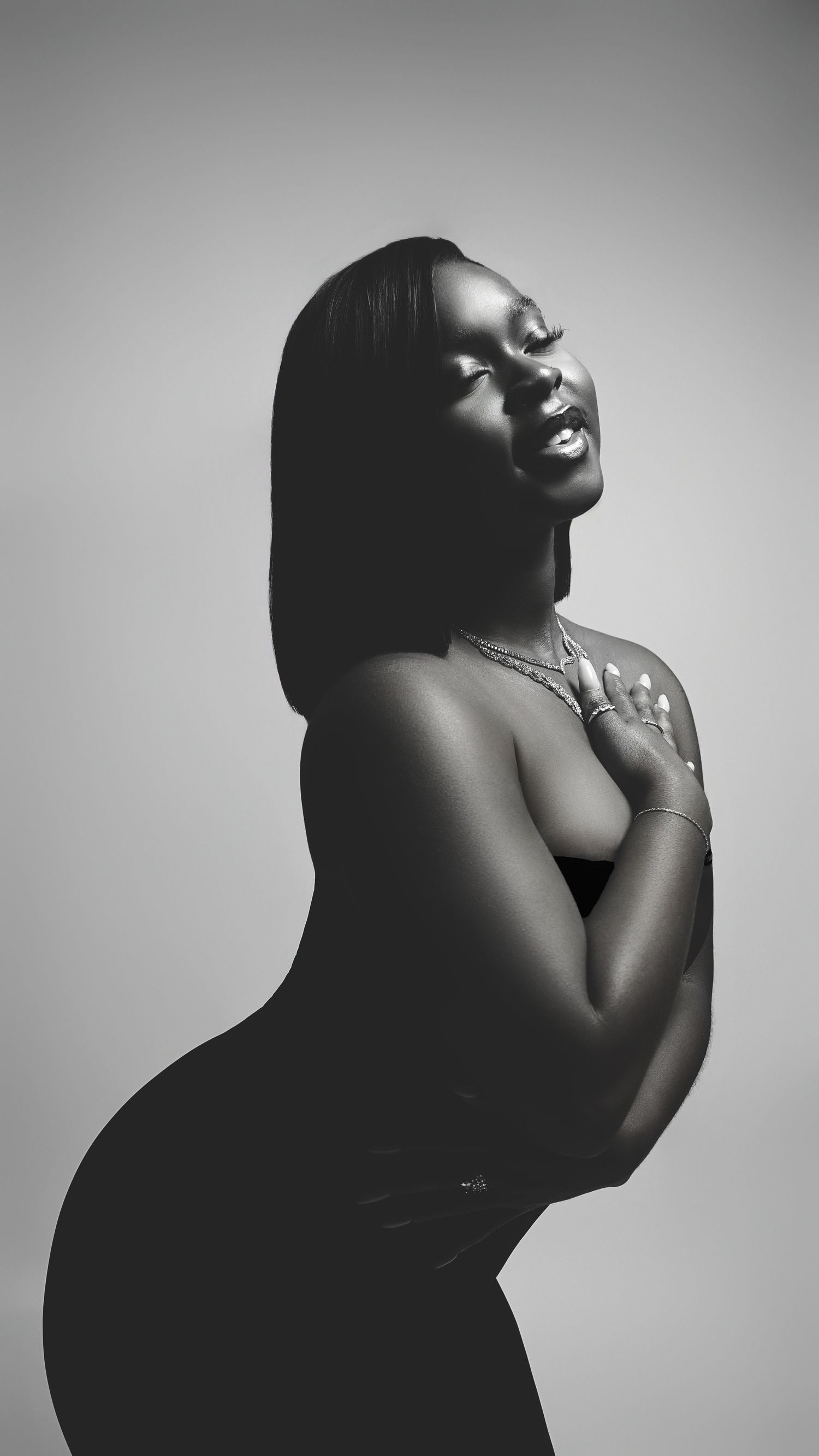 Artistic black and white portrait series showing elegant poses in dramatic lighting.